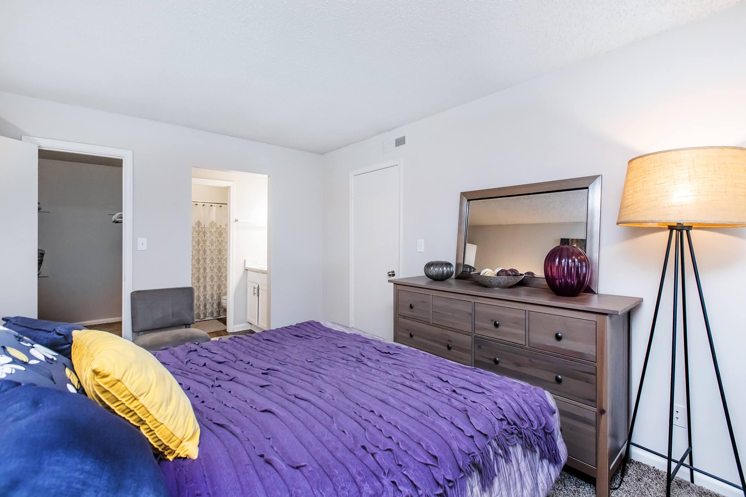 a bedroom with a purple bed