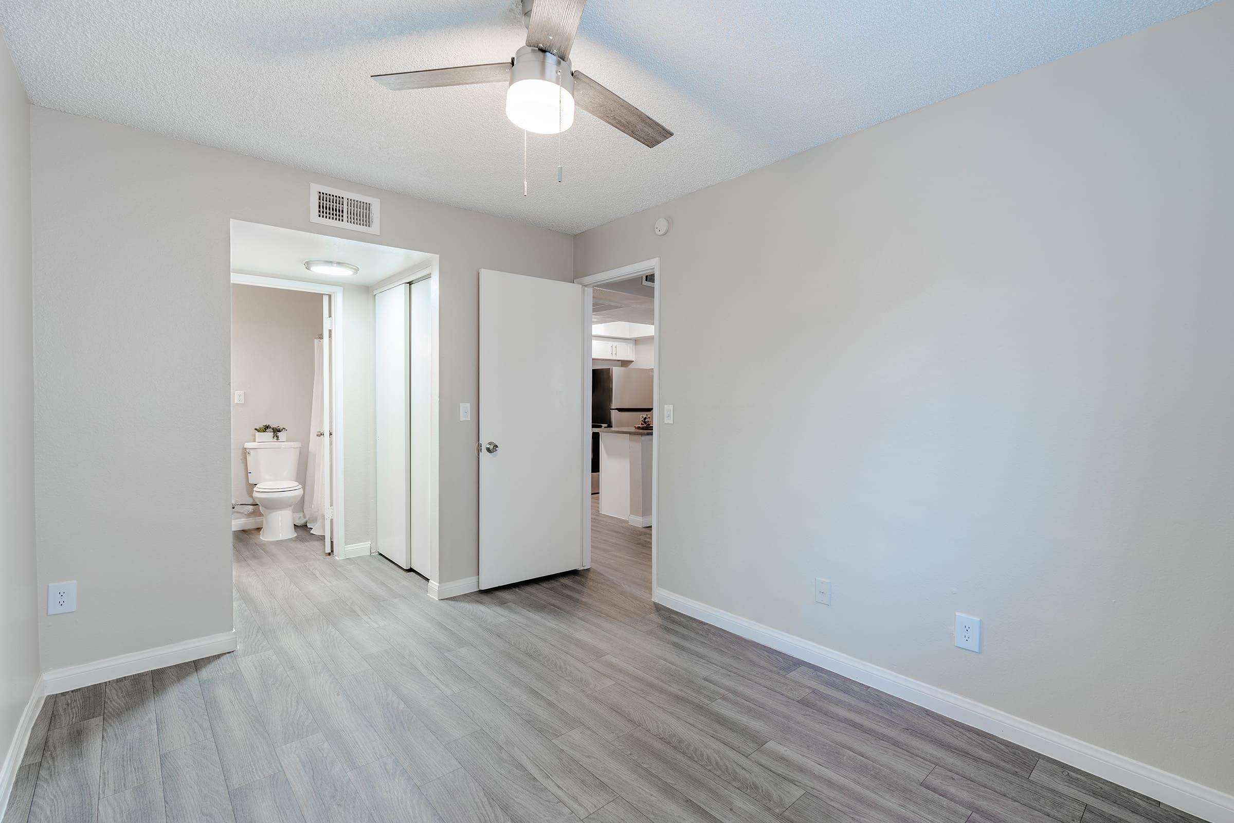 Open modern bedroom space with attached walkway to a bathroom