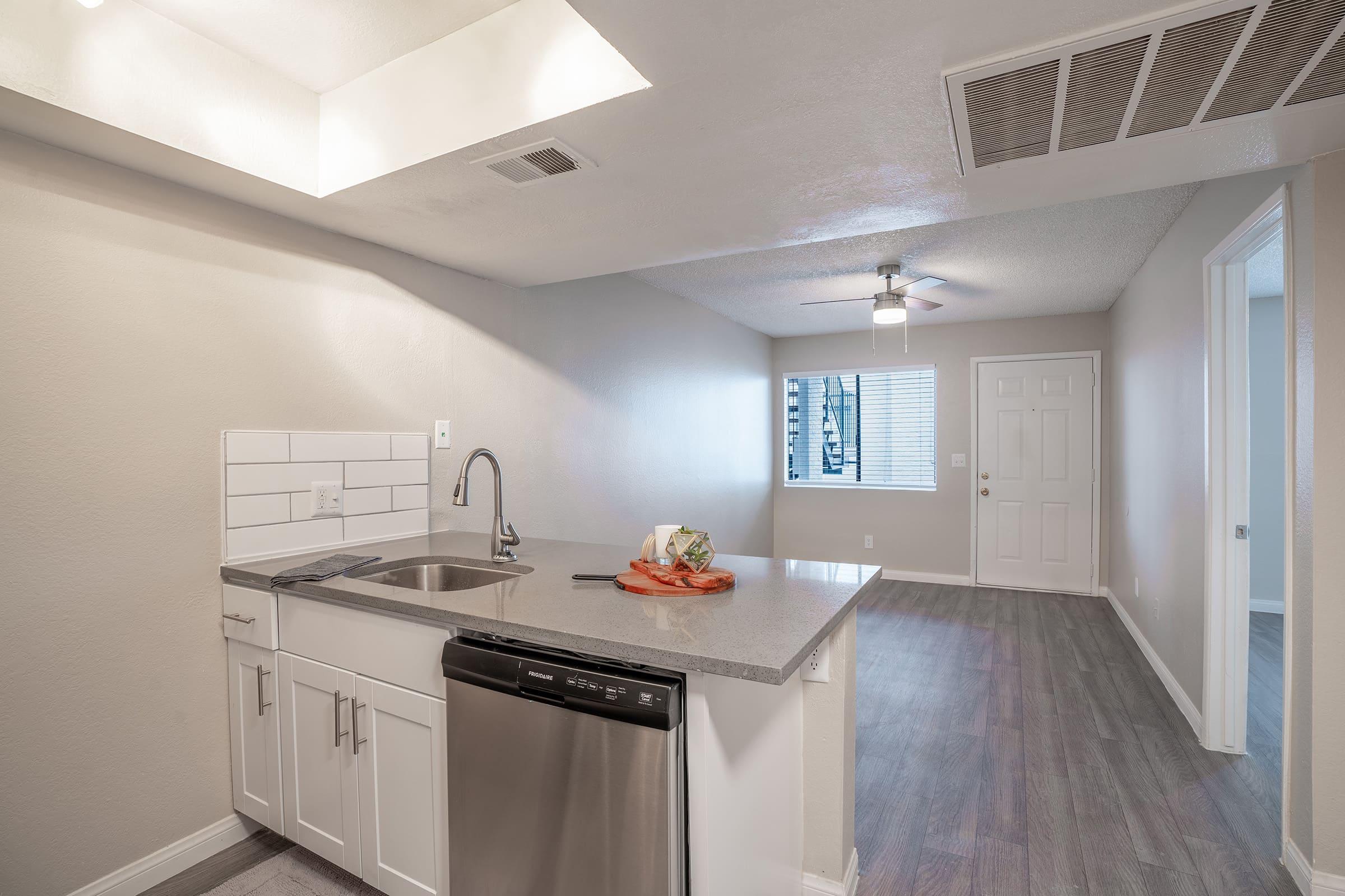 Large kitchen island in front of large empty modern living room space