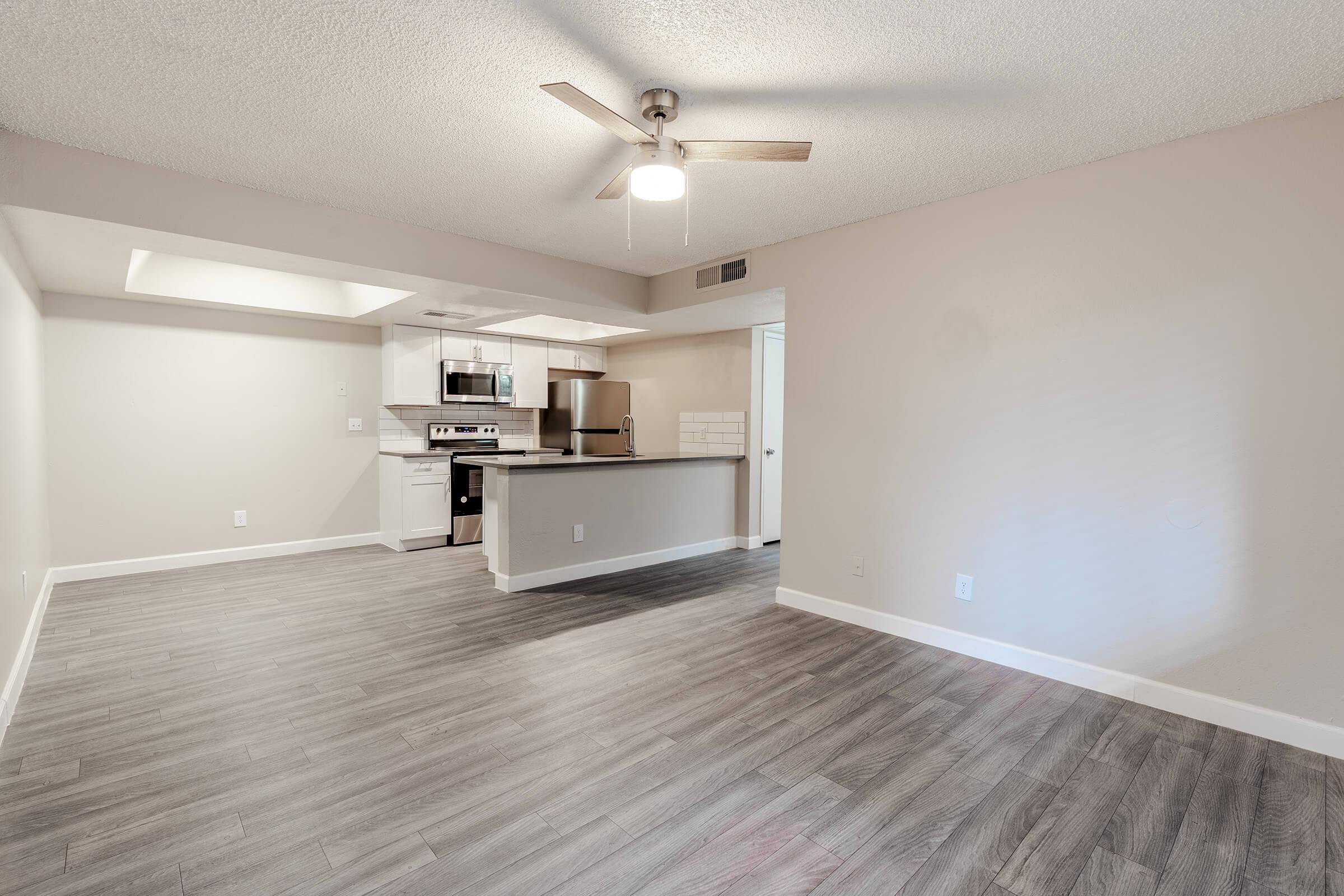 Open spacious living room with attached dining room space and kitchen