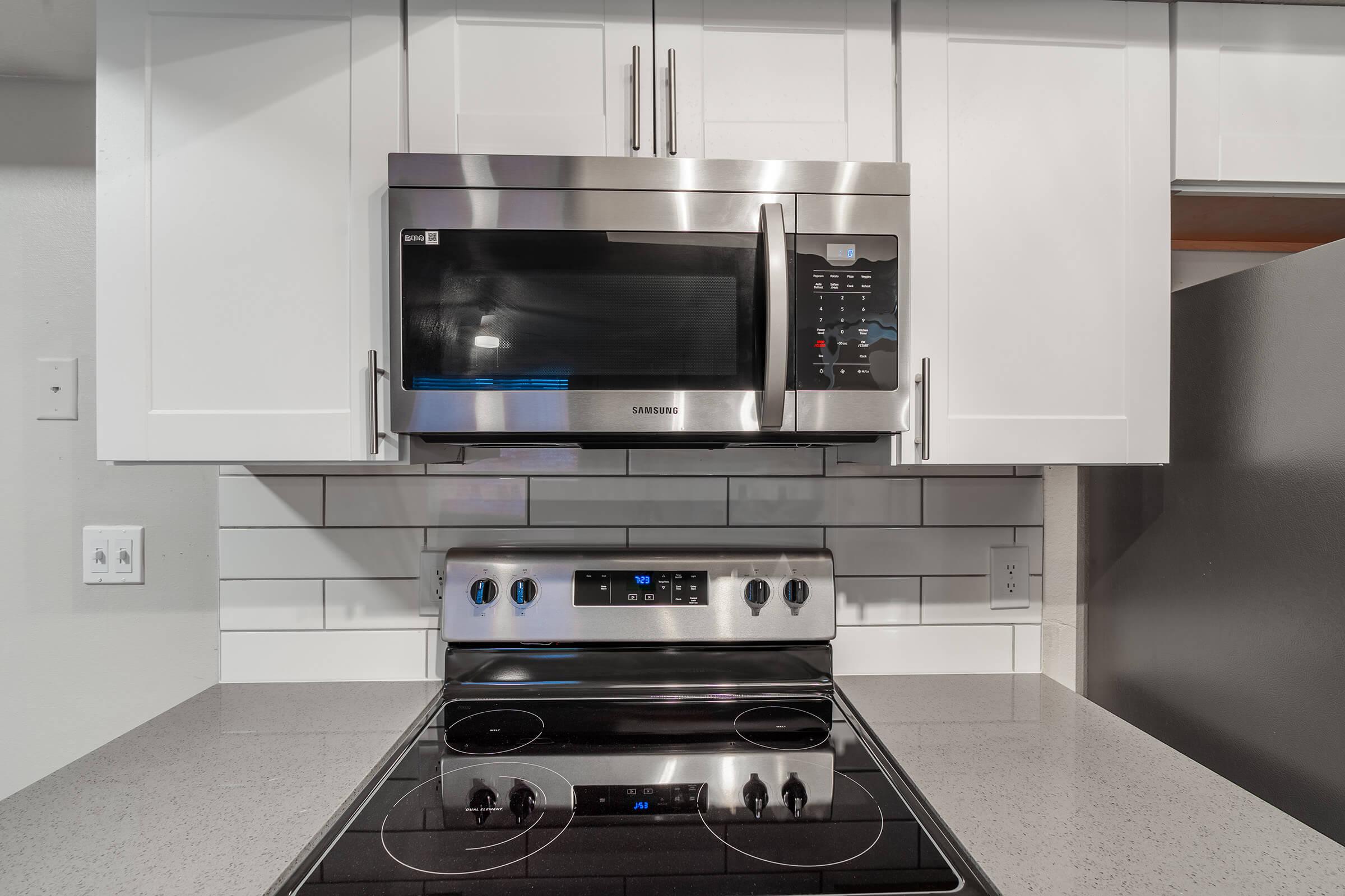 Close up view of microwave and stove top