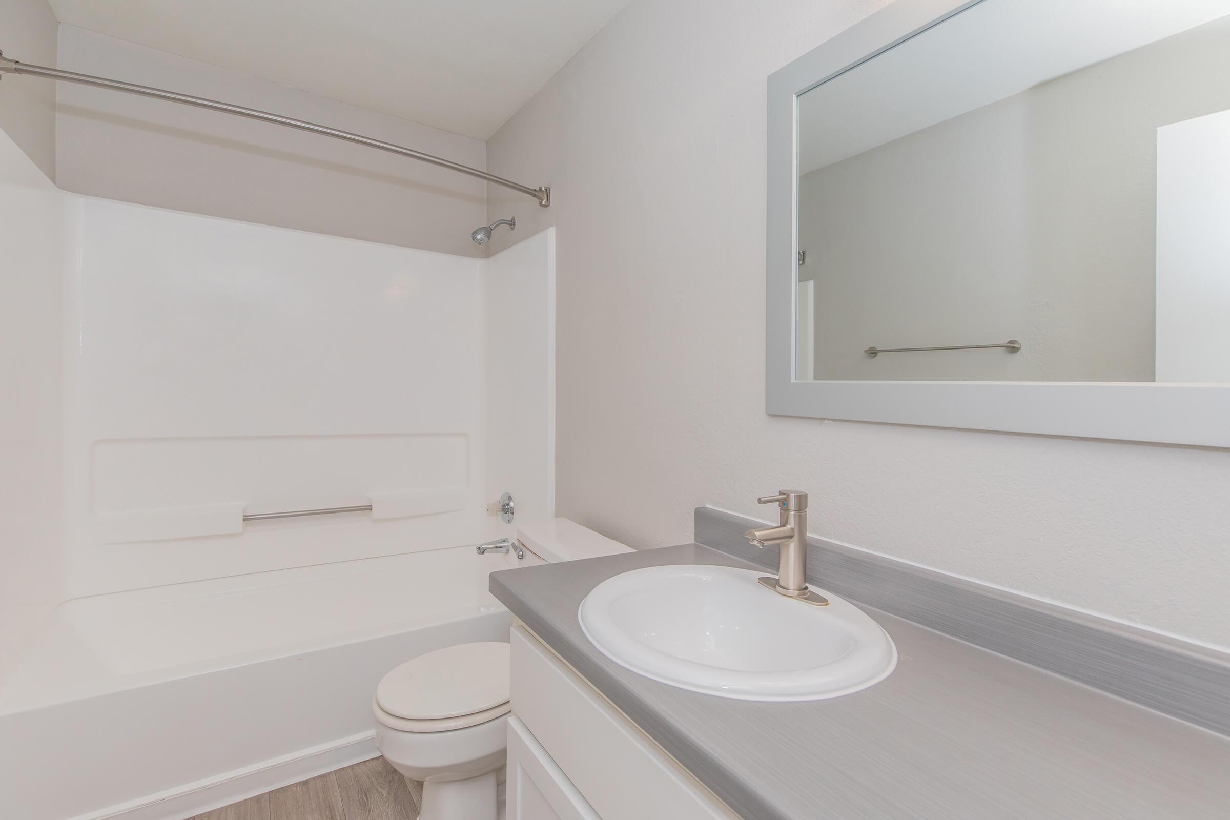 Fresh contemporary bathroom with shower, tub, toilet, and sink vanity