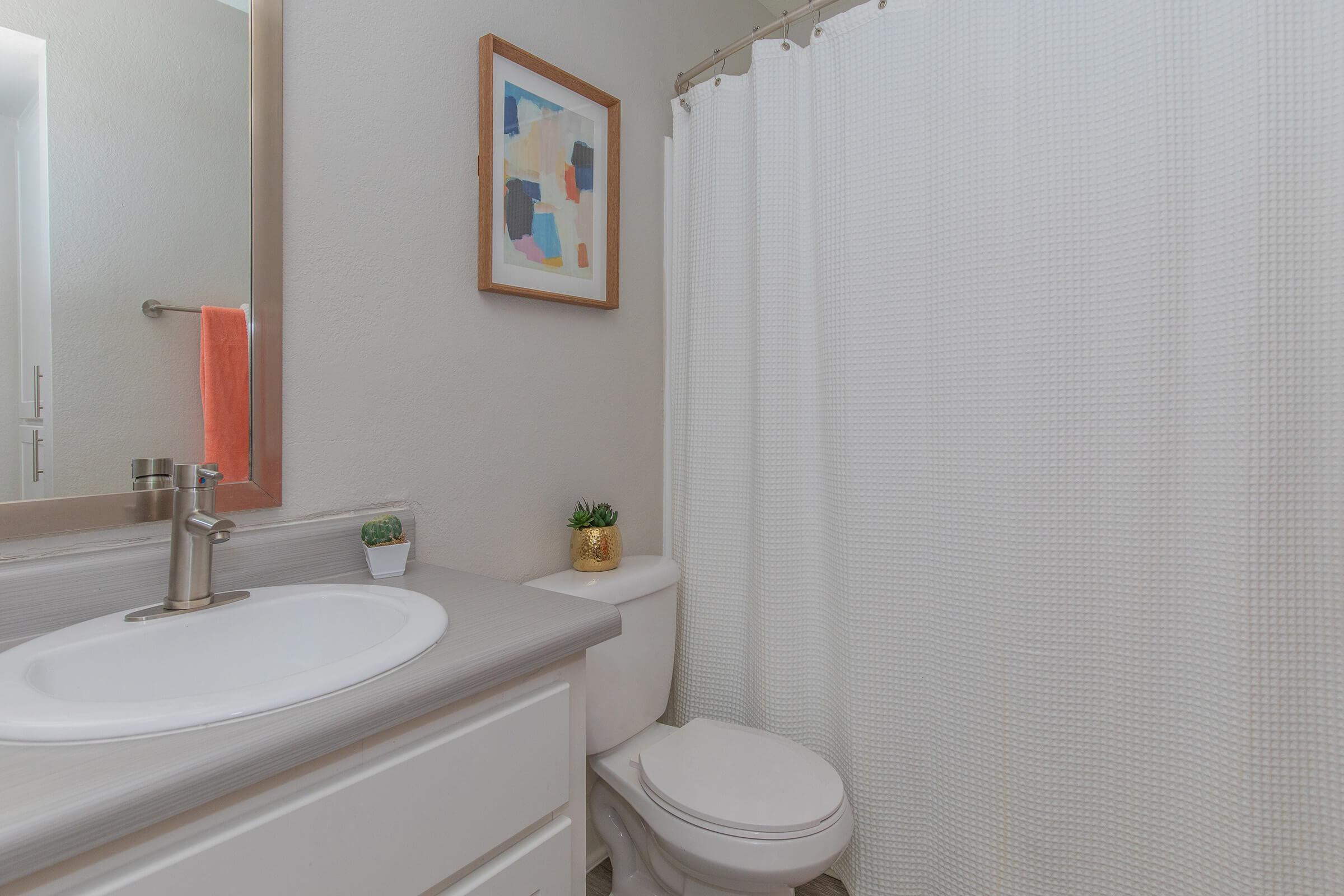 Clean bathroom with shower, tub, toilet, and mirrored sink vanity