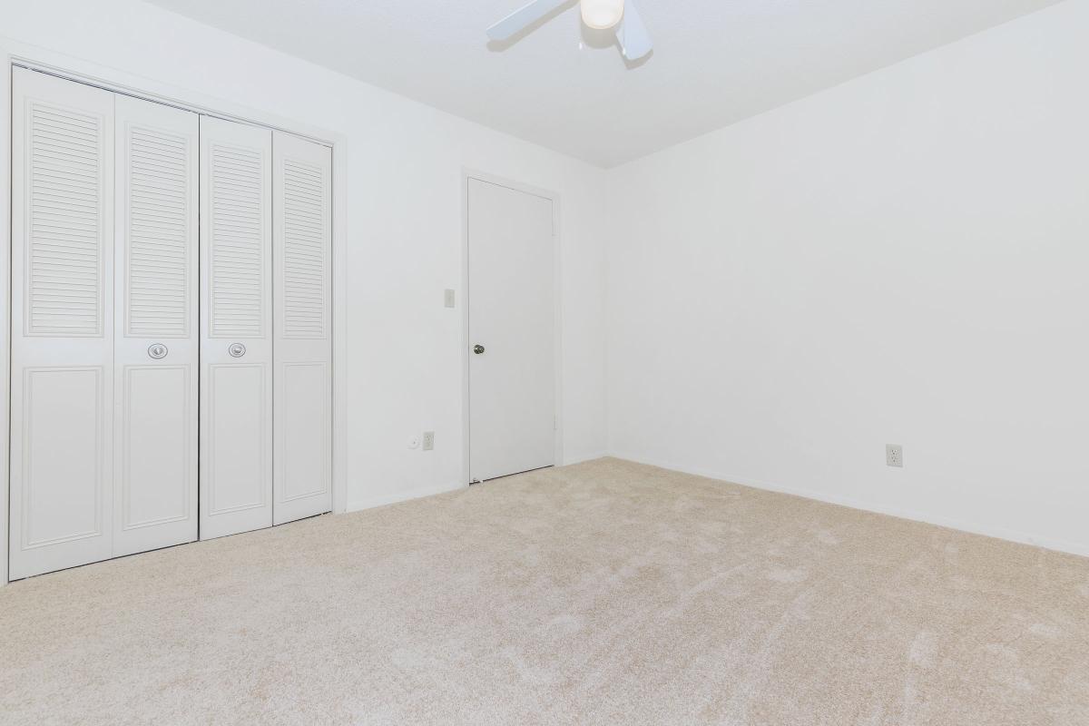 a bedroom with a bed in a room
