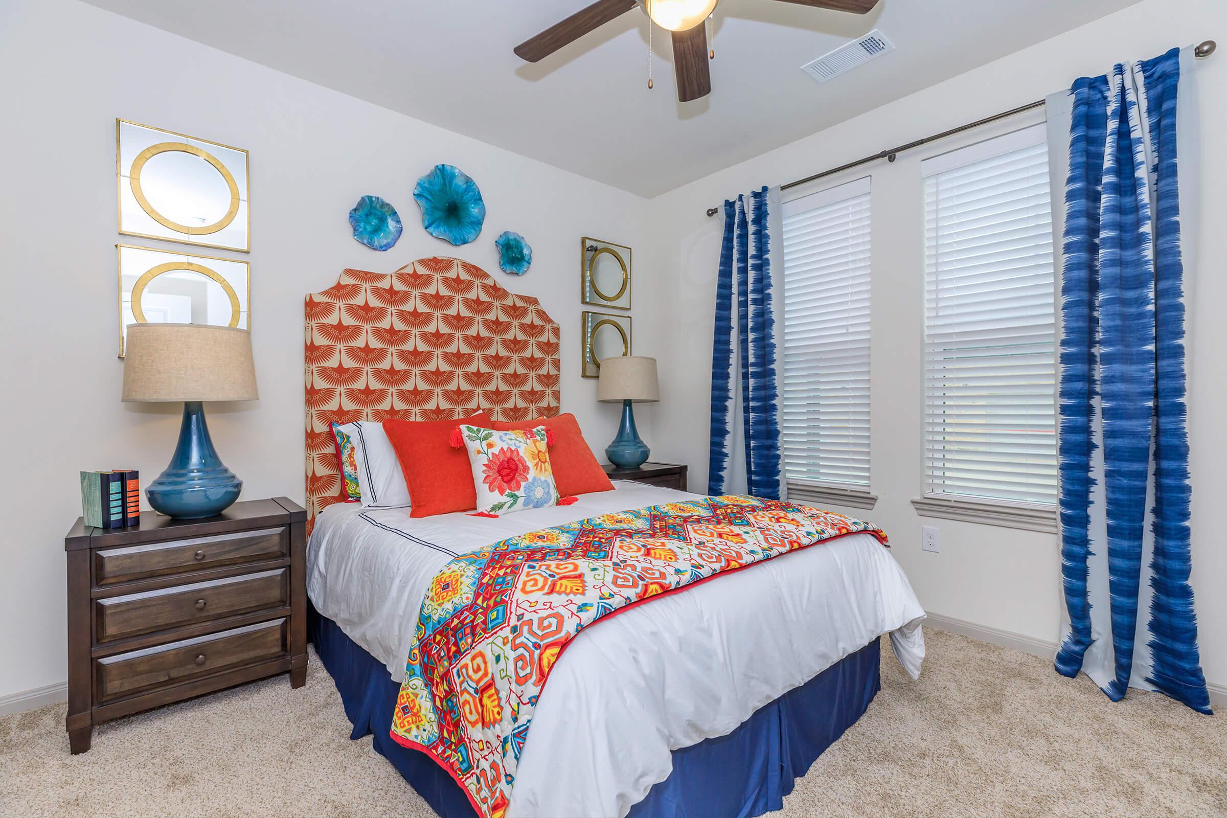 a bedroom with a bed and desk in a room