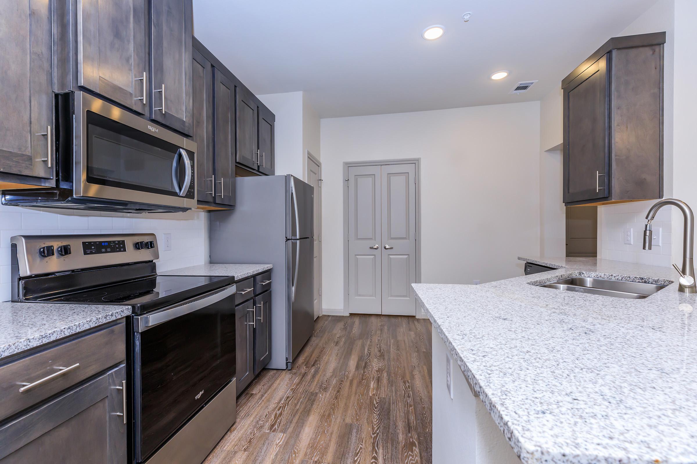 a large kitchen with stainless steel appliances