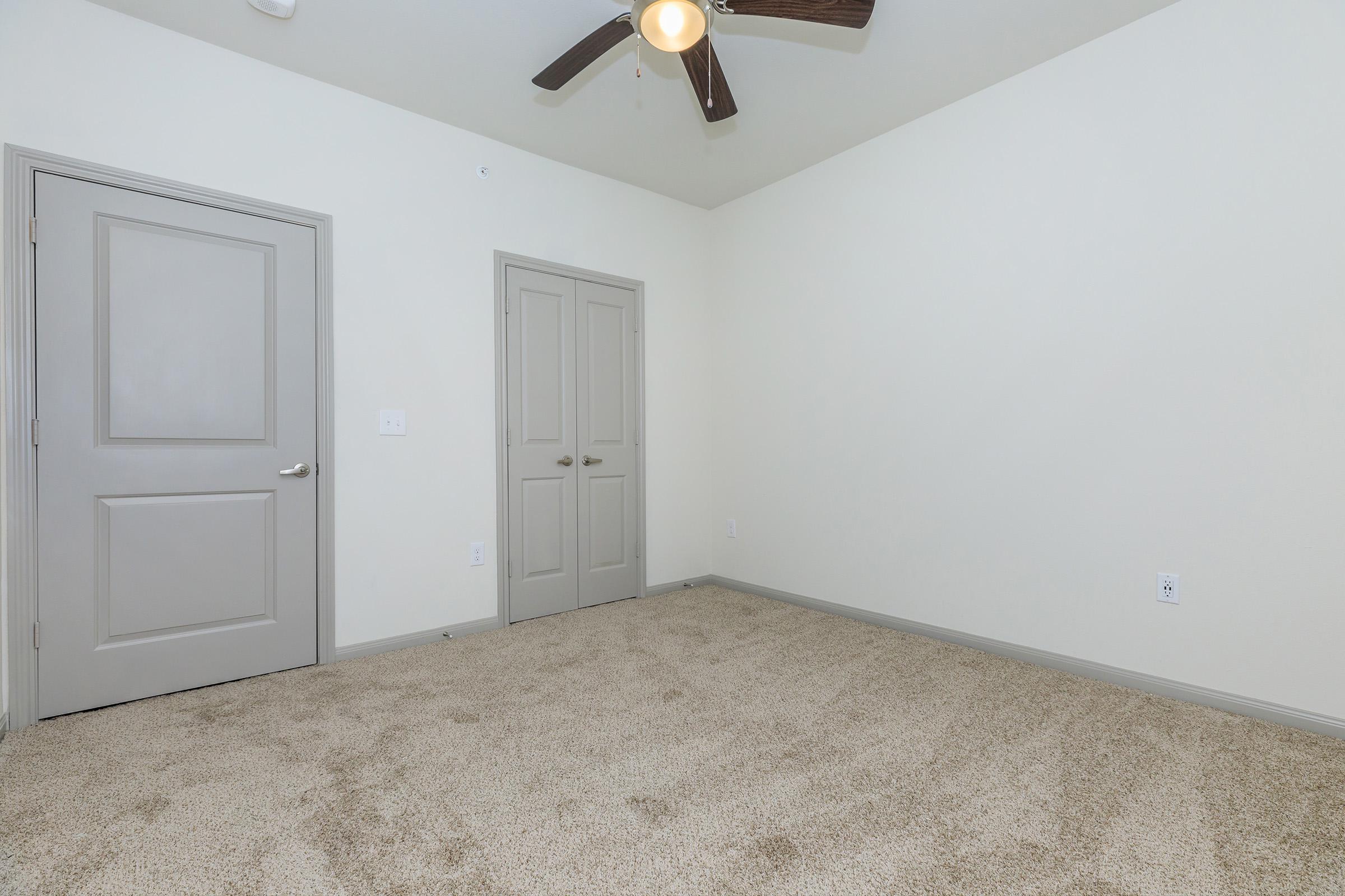 a bedroom with a bed and a mirror