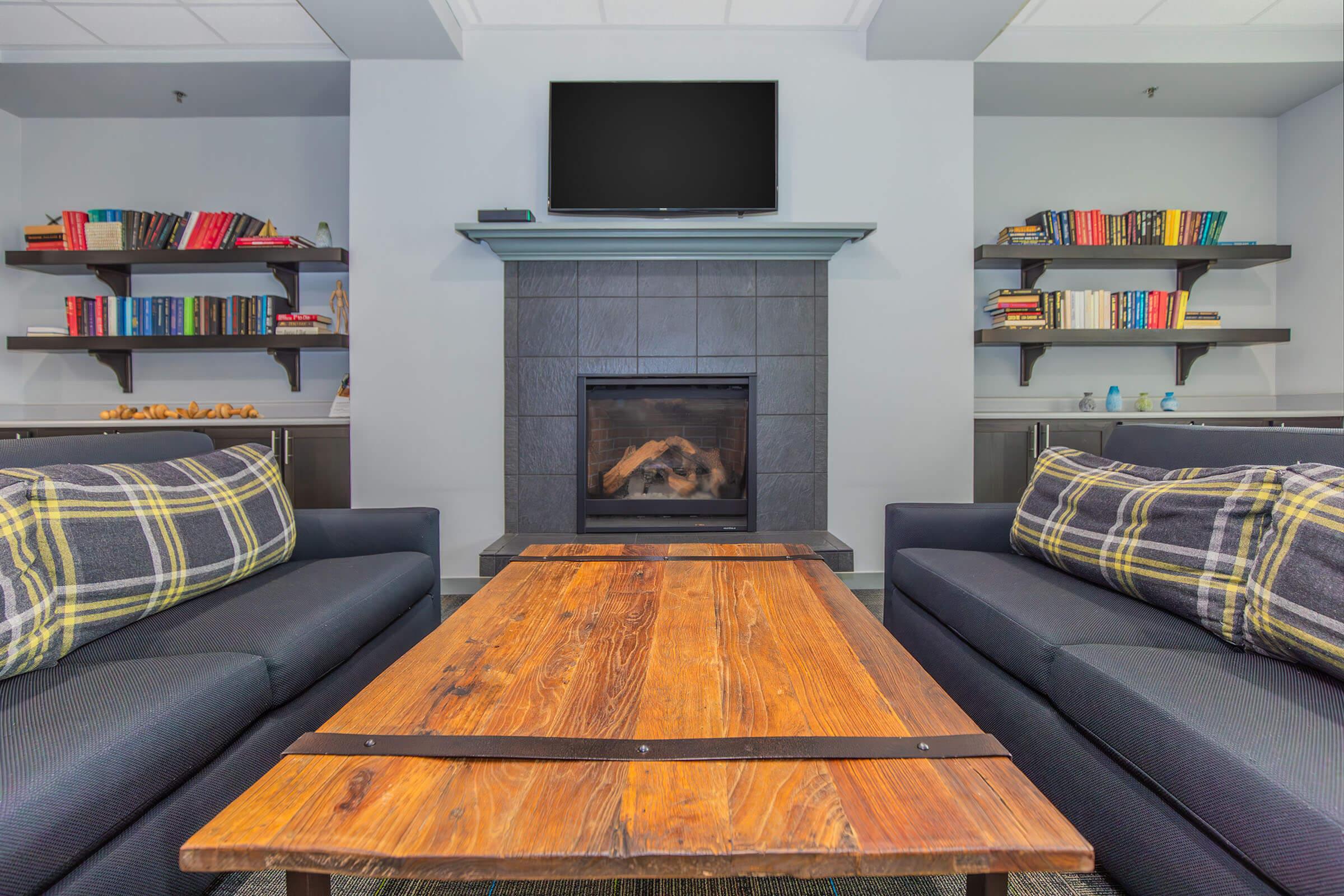 a living room filled with furniture and a fire place