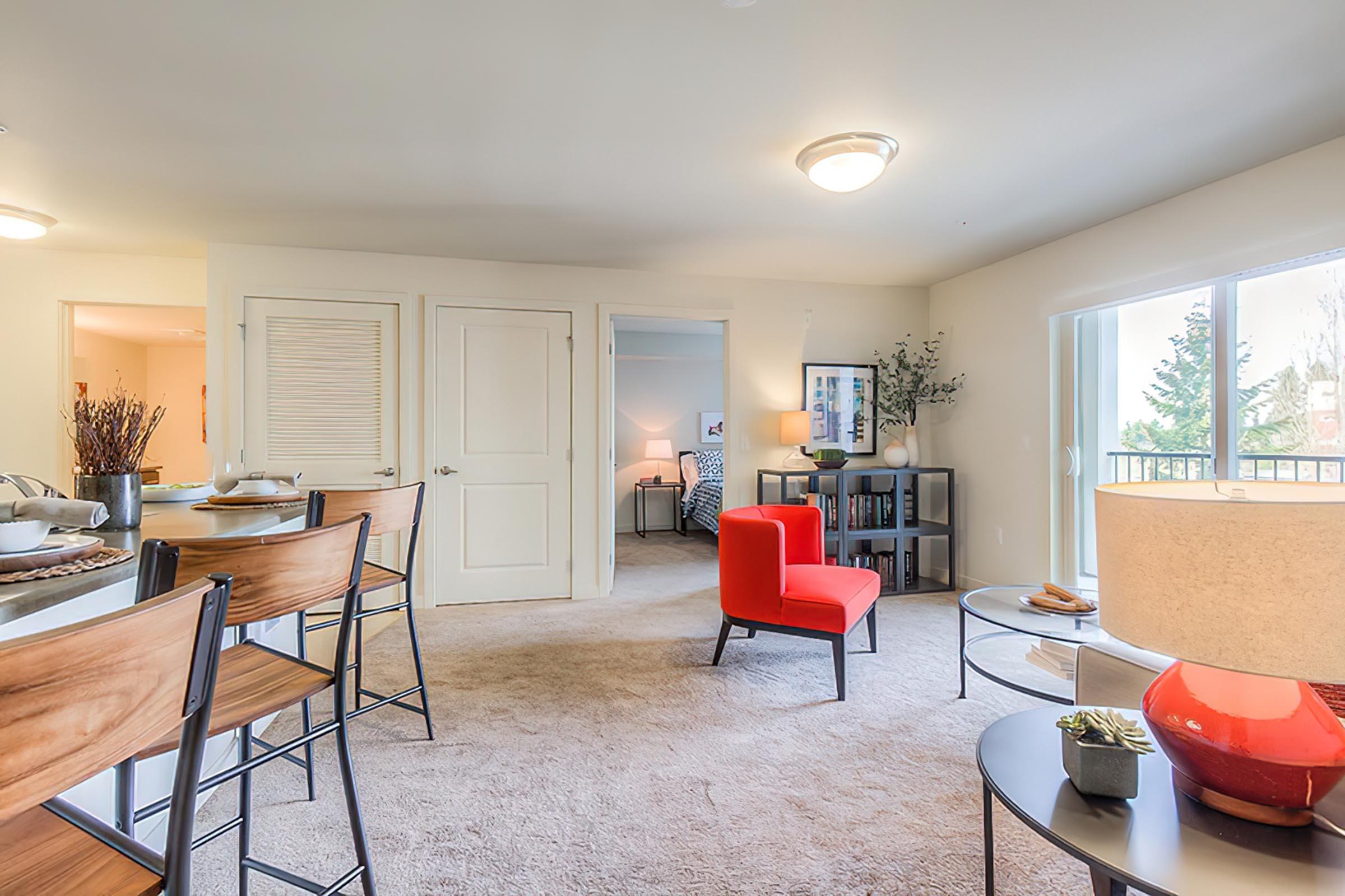 a living room filled with furniture and a large window