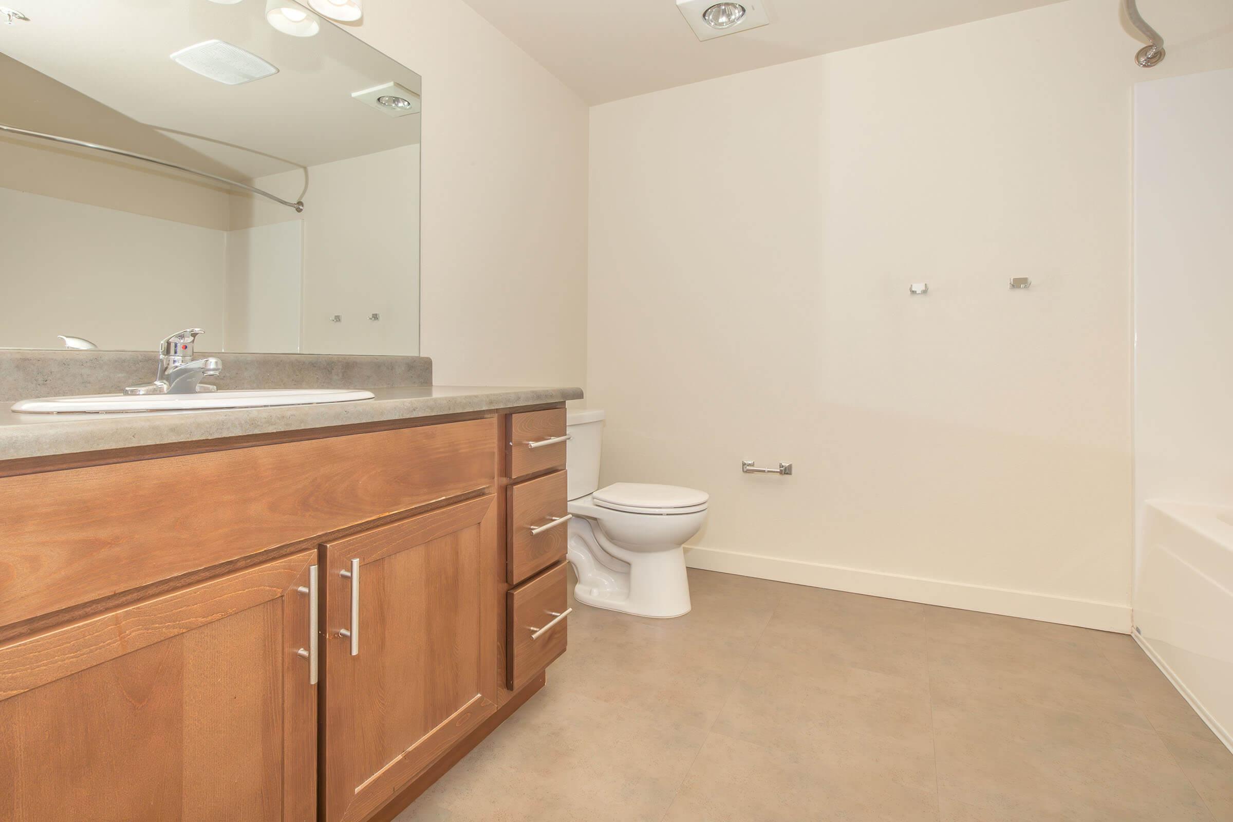 a kitchen with a sink and a mirror