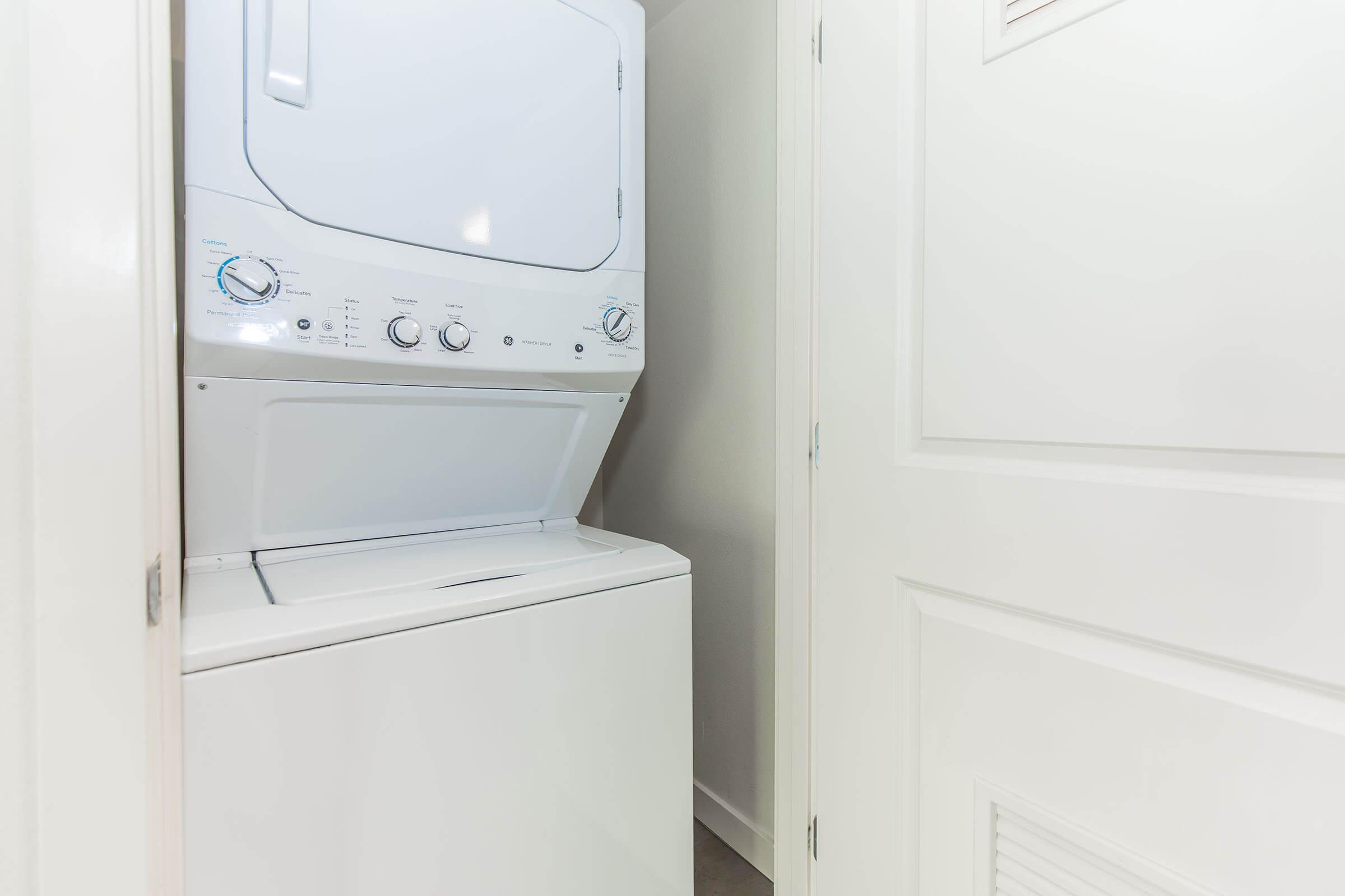 a microwave oven sitting on top of a refrigerator