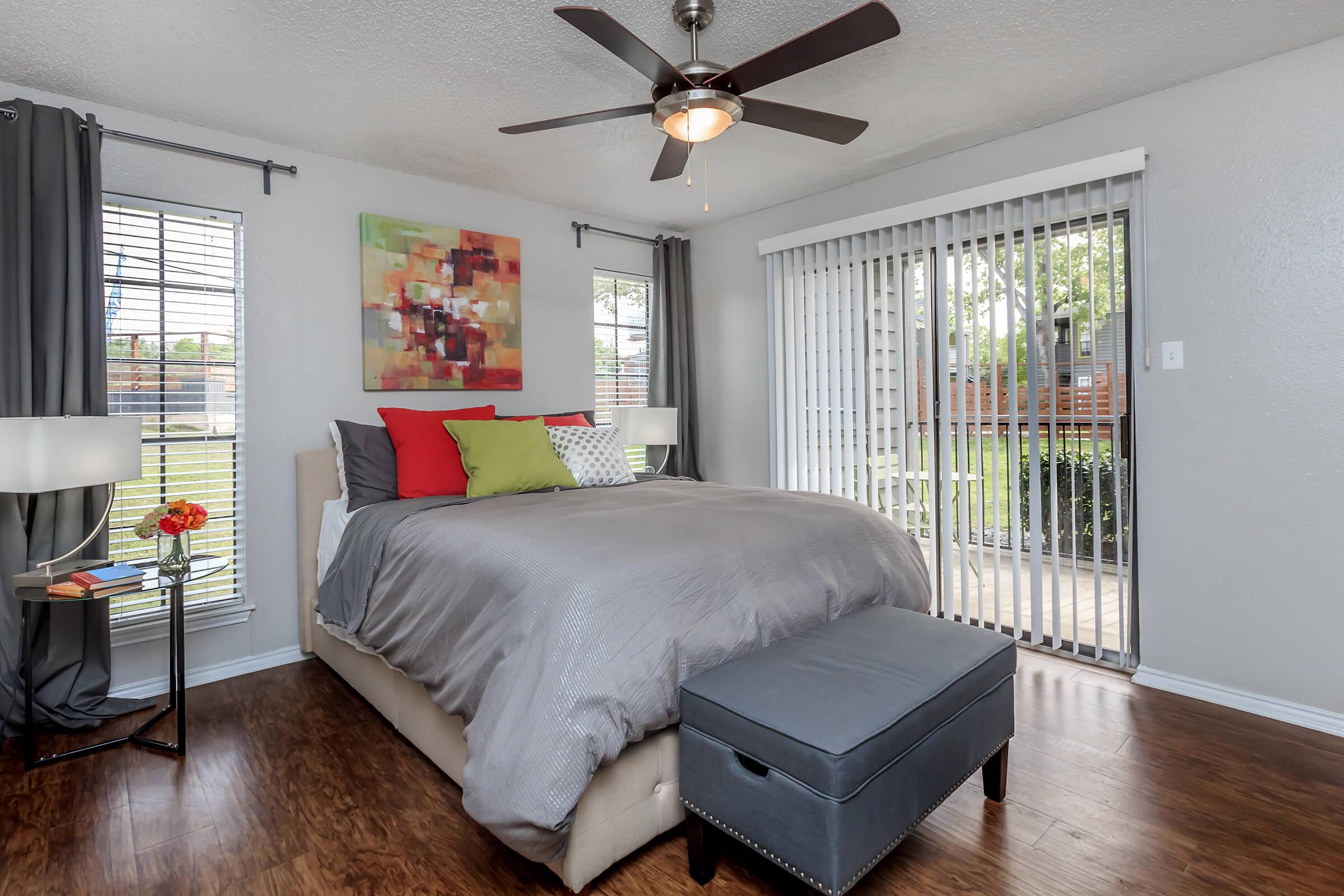 a bedroom with a bed and desk in a room