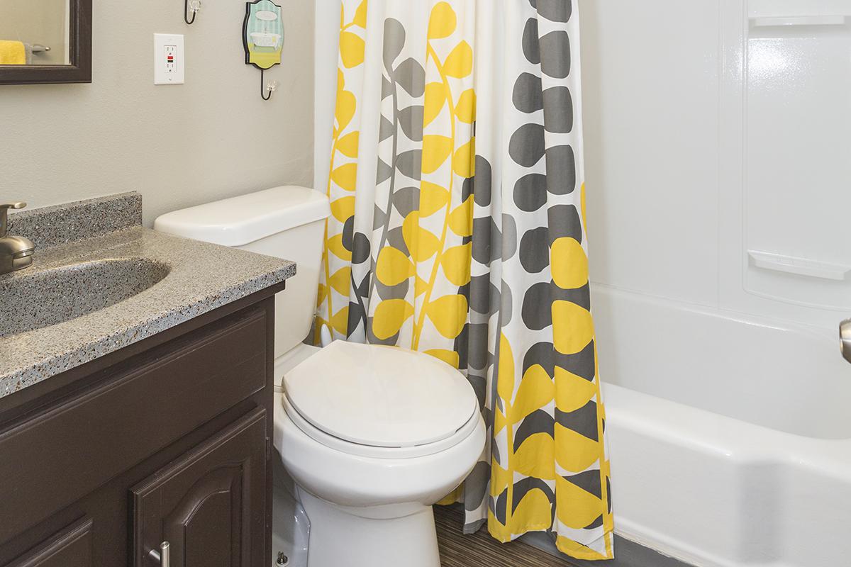 a white sink sitting next to a shower