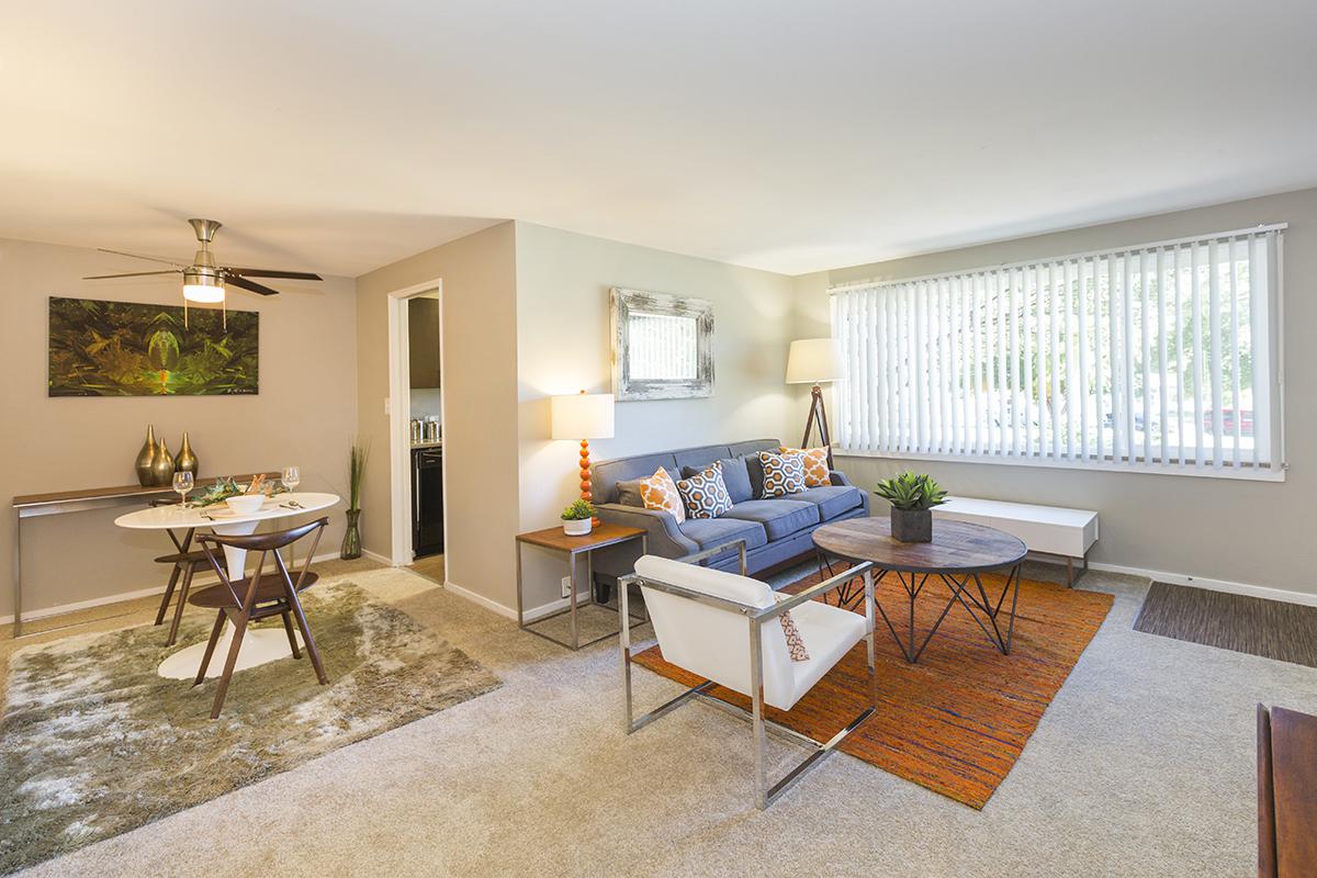 a living room filled with furniture and a large window