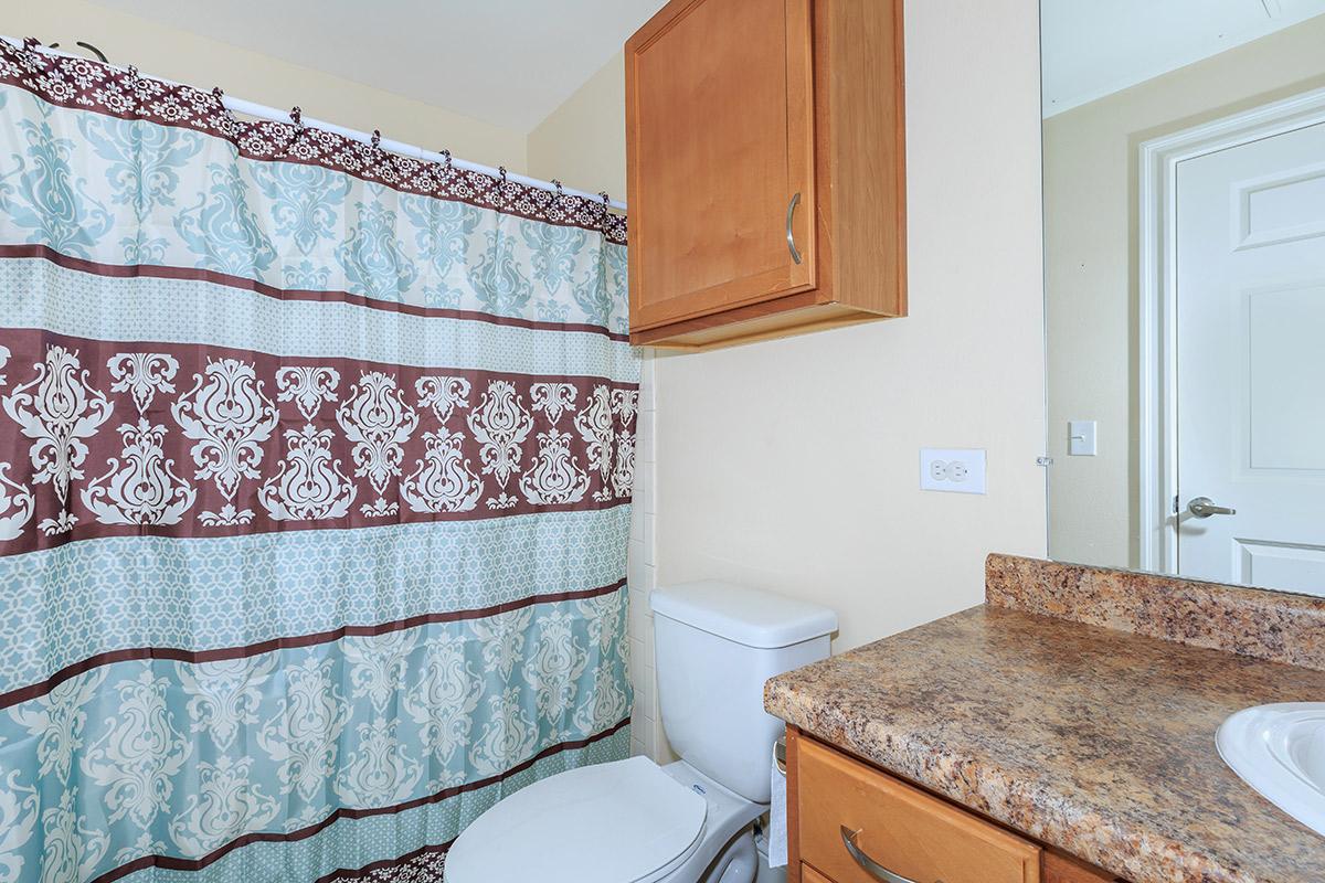 a bedroom area with a sink and a mirror