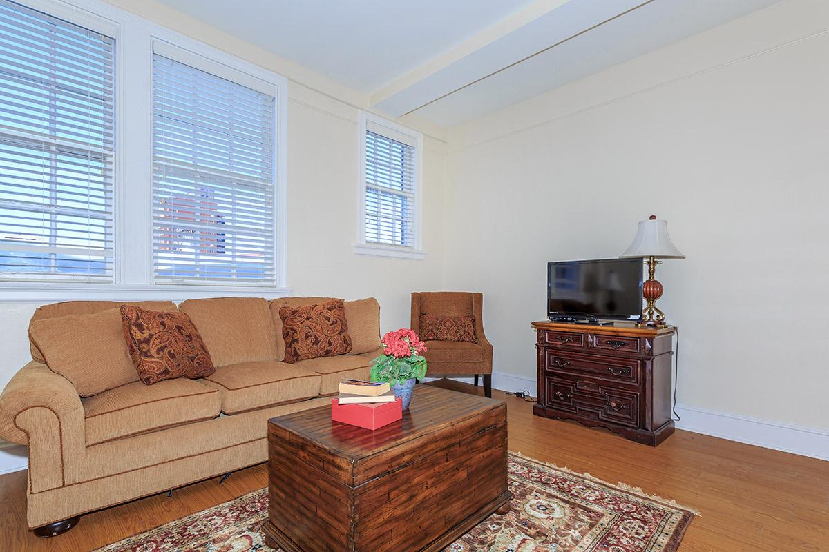 a living room filled with furniture and a large window