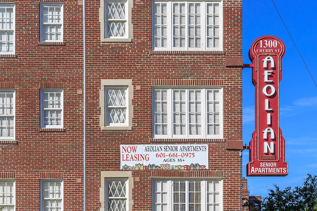 a sign in front of a brick building