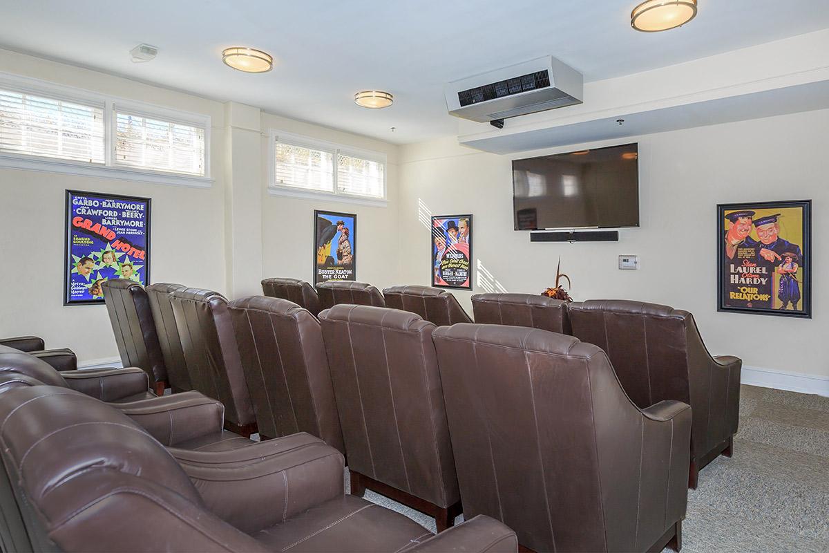 a living room filled with furniture and a flat screen tv