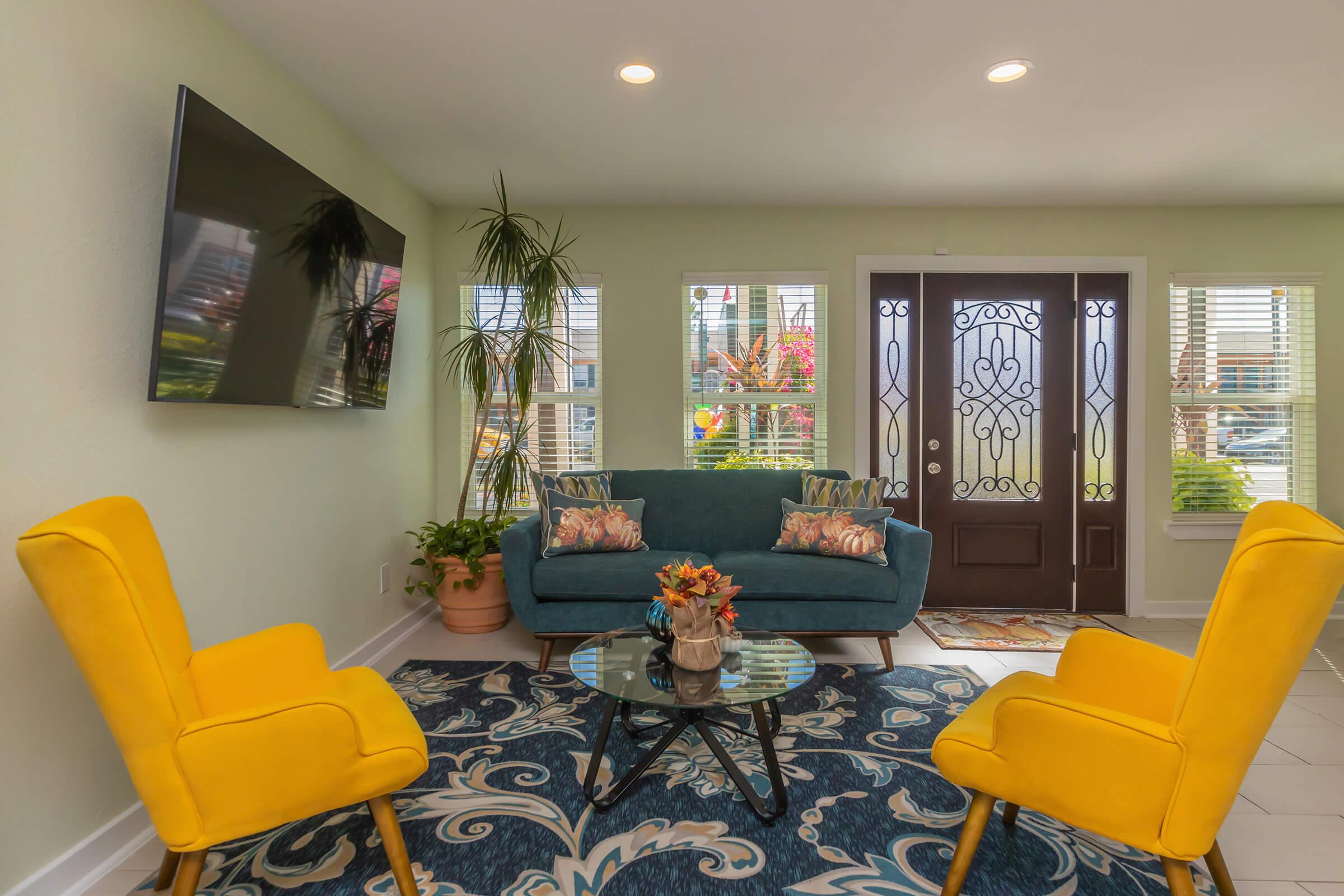 a living room filled with furniture and a large window