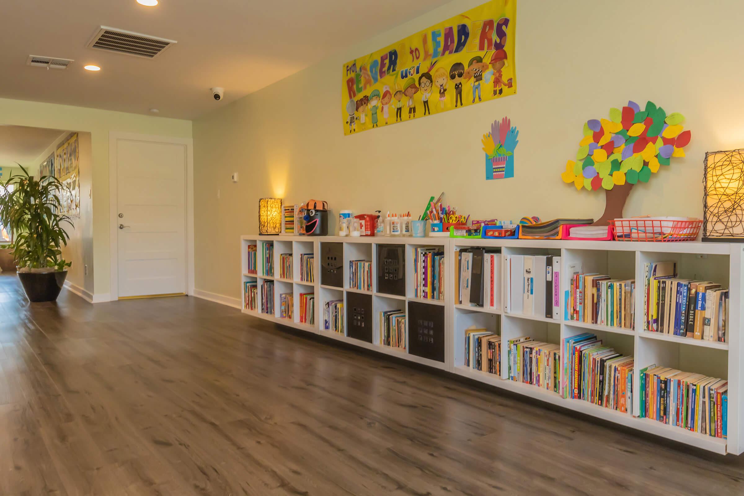 a room filled with furniture and a book shelf