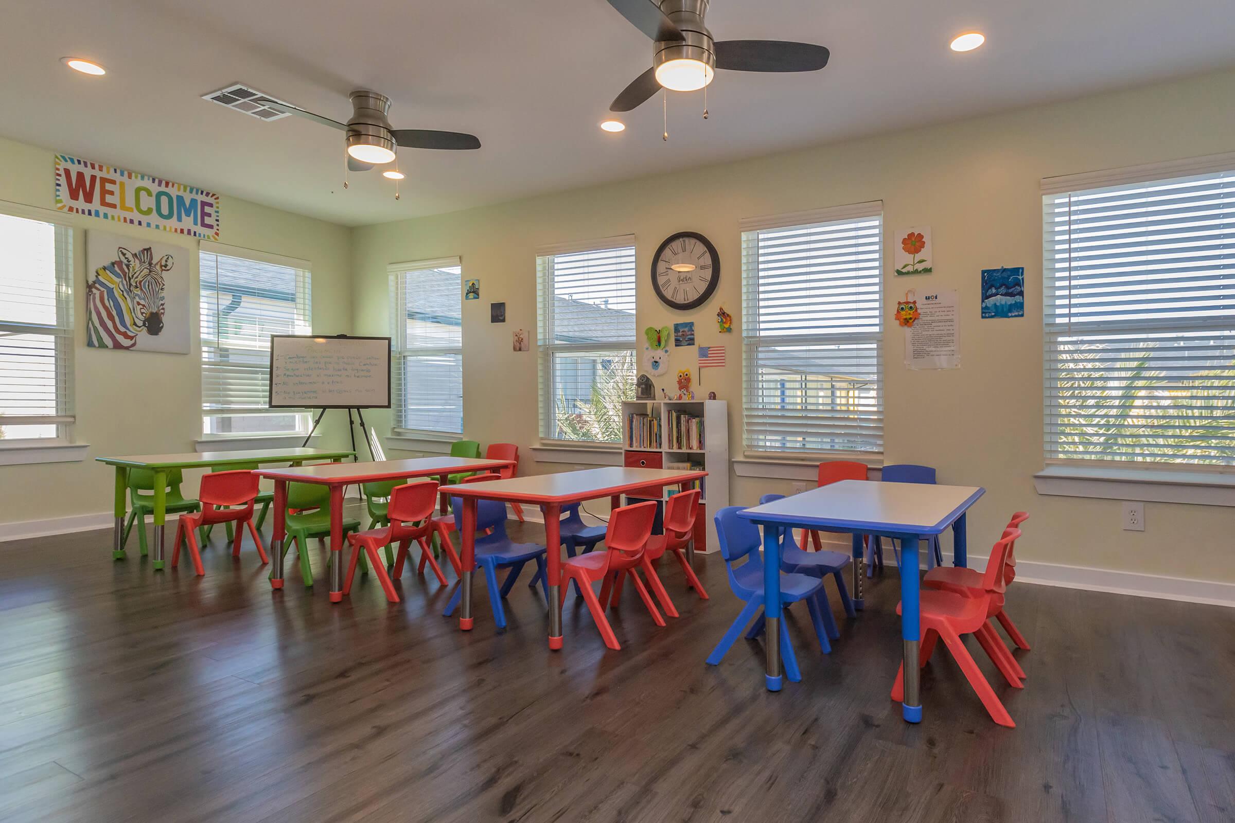 a group of people in a room with a wooden floor