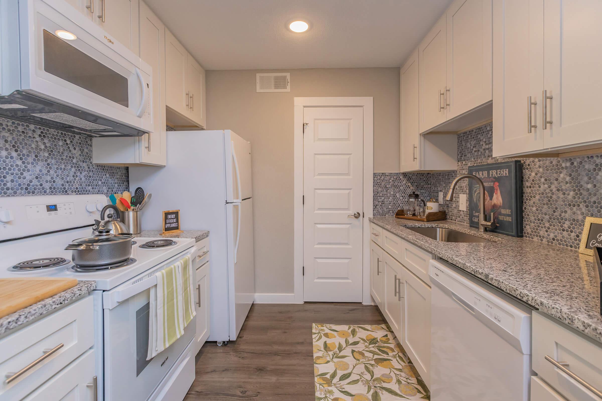 a kitchen with a stove sink and refrigerator