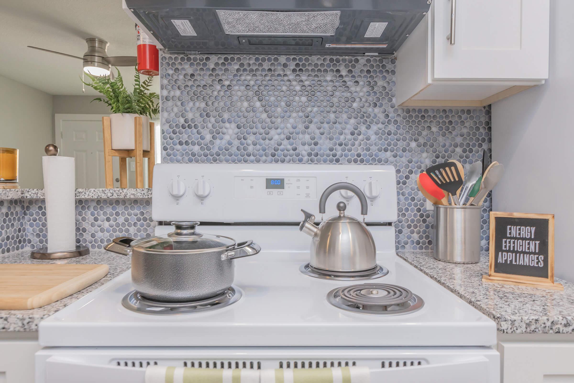 a stove top oven sitting inside of a kitchen