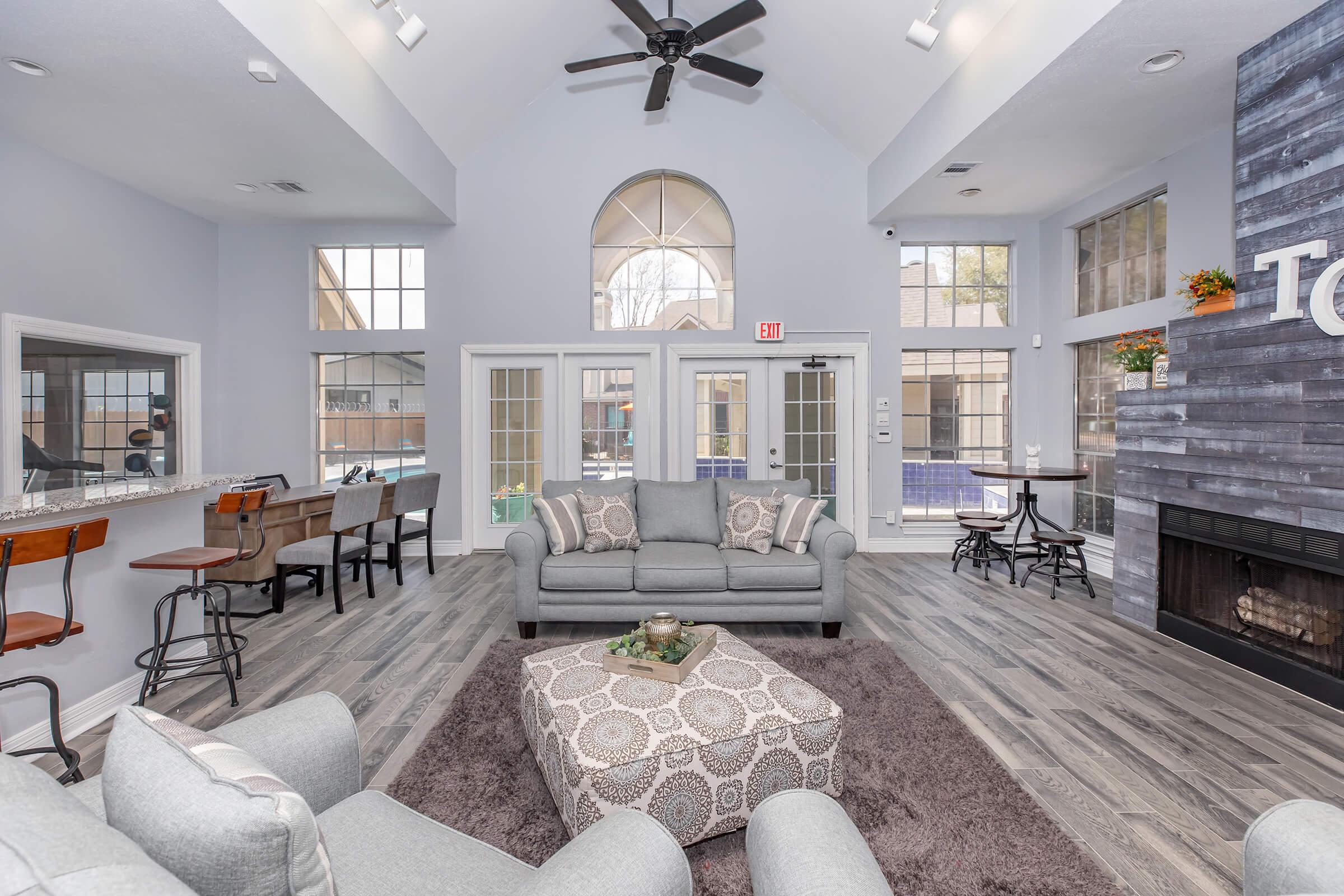 a living room filled with furniture and a large window