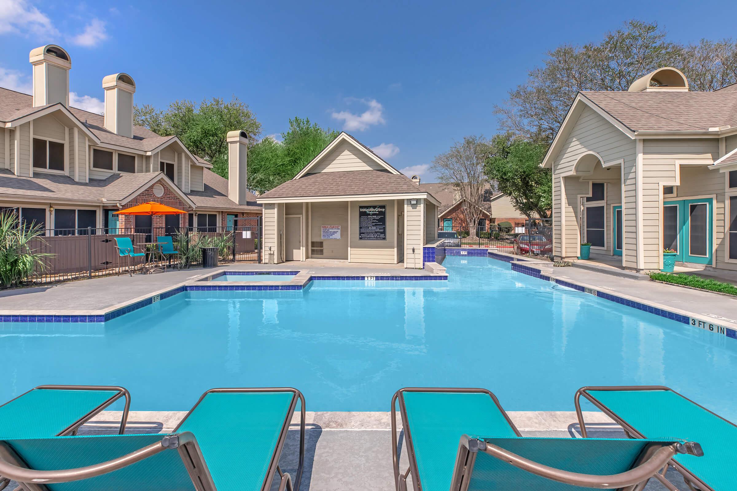 a house with a pool in front of a building