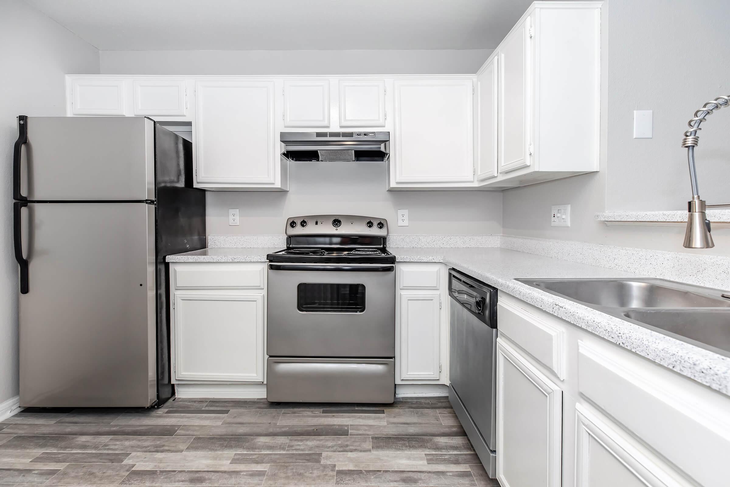 a kitchen with a stove and a refrigerator