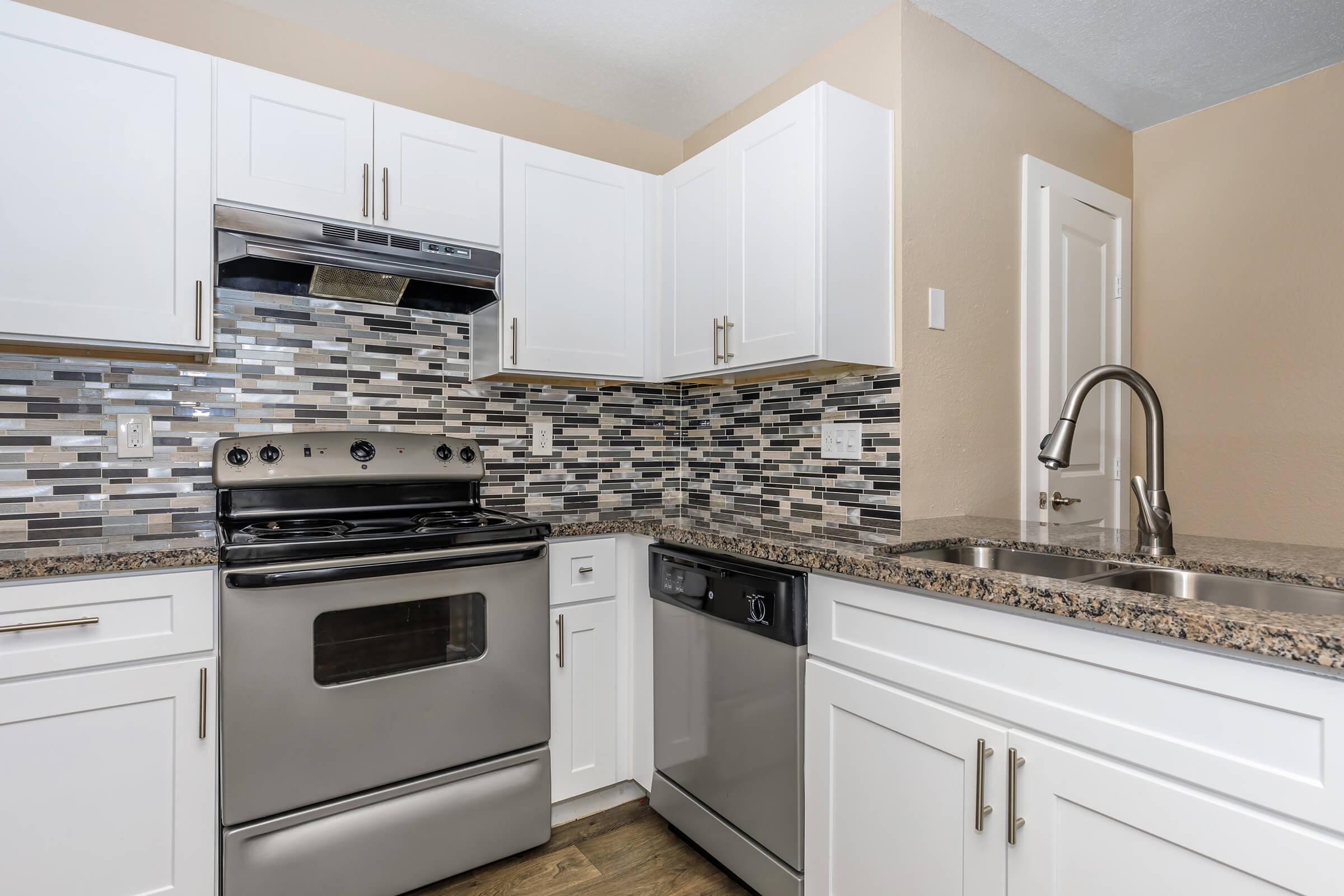 a stove top oven sitting inside of a kitchen