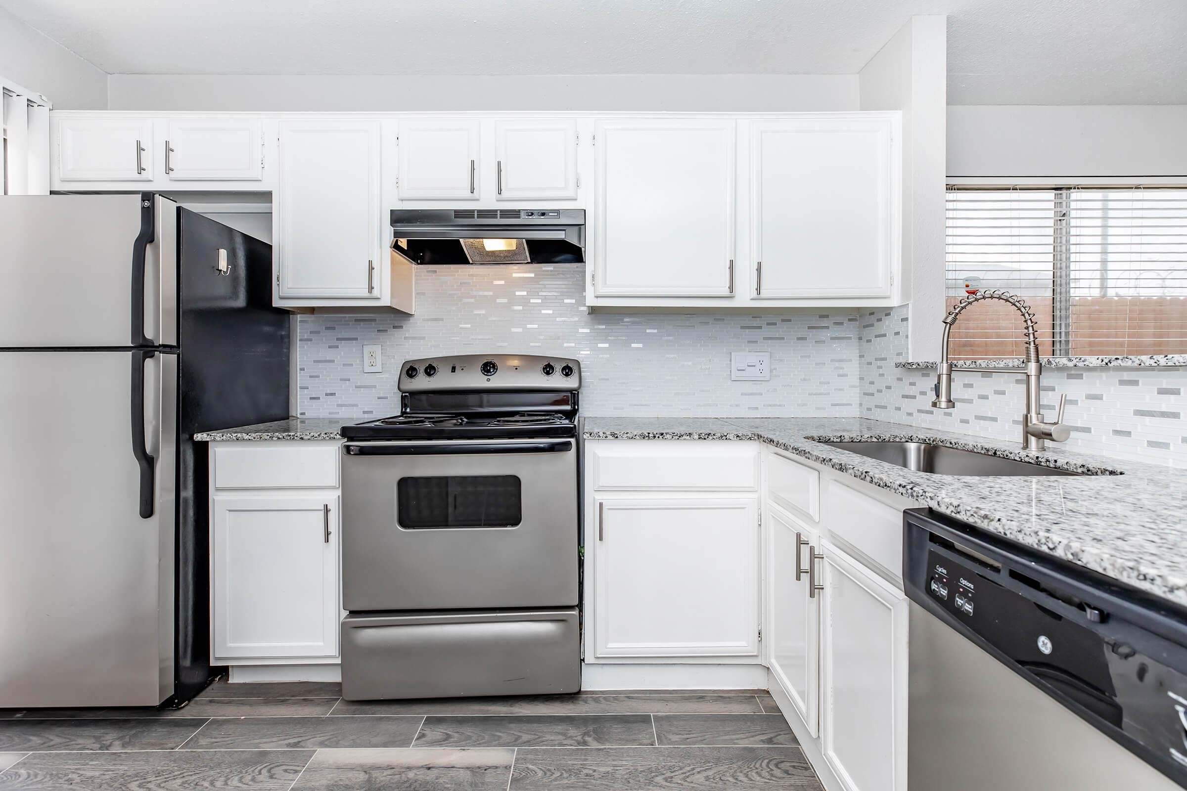 a kitchen with a stove and a refrigerator