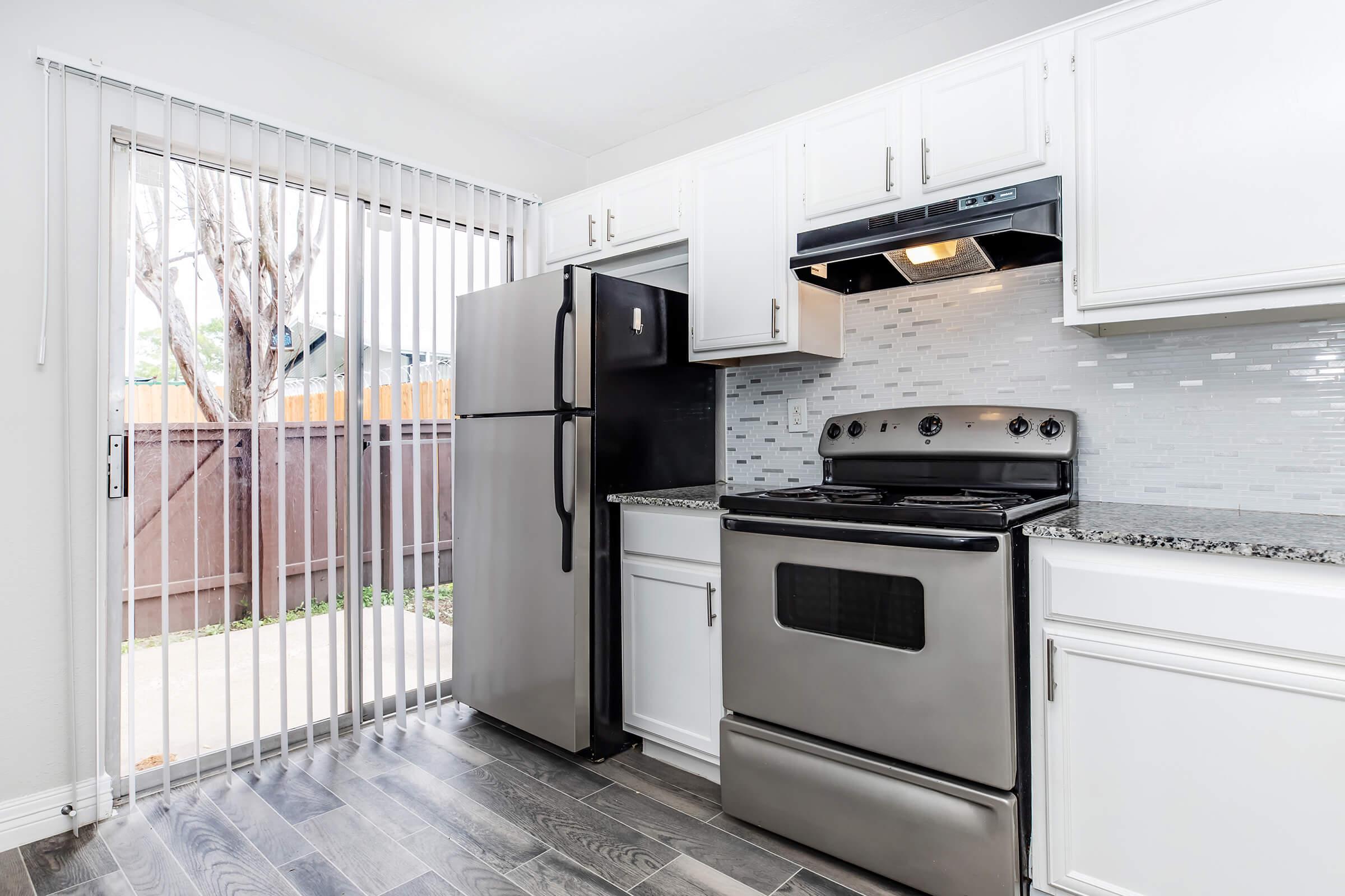 a stove top oven sitting inside of a kitchen