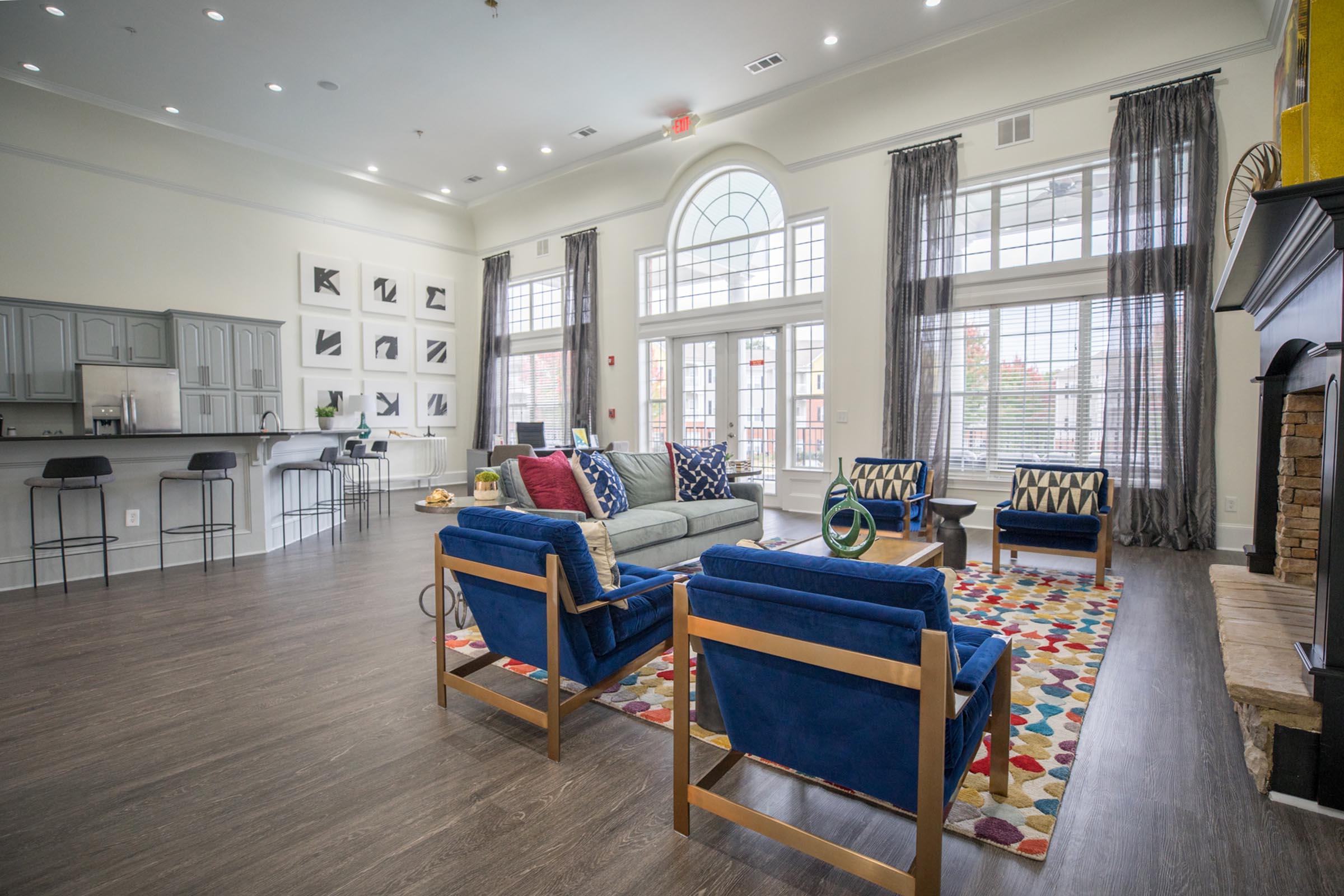 a living room filled with furniture and a large window