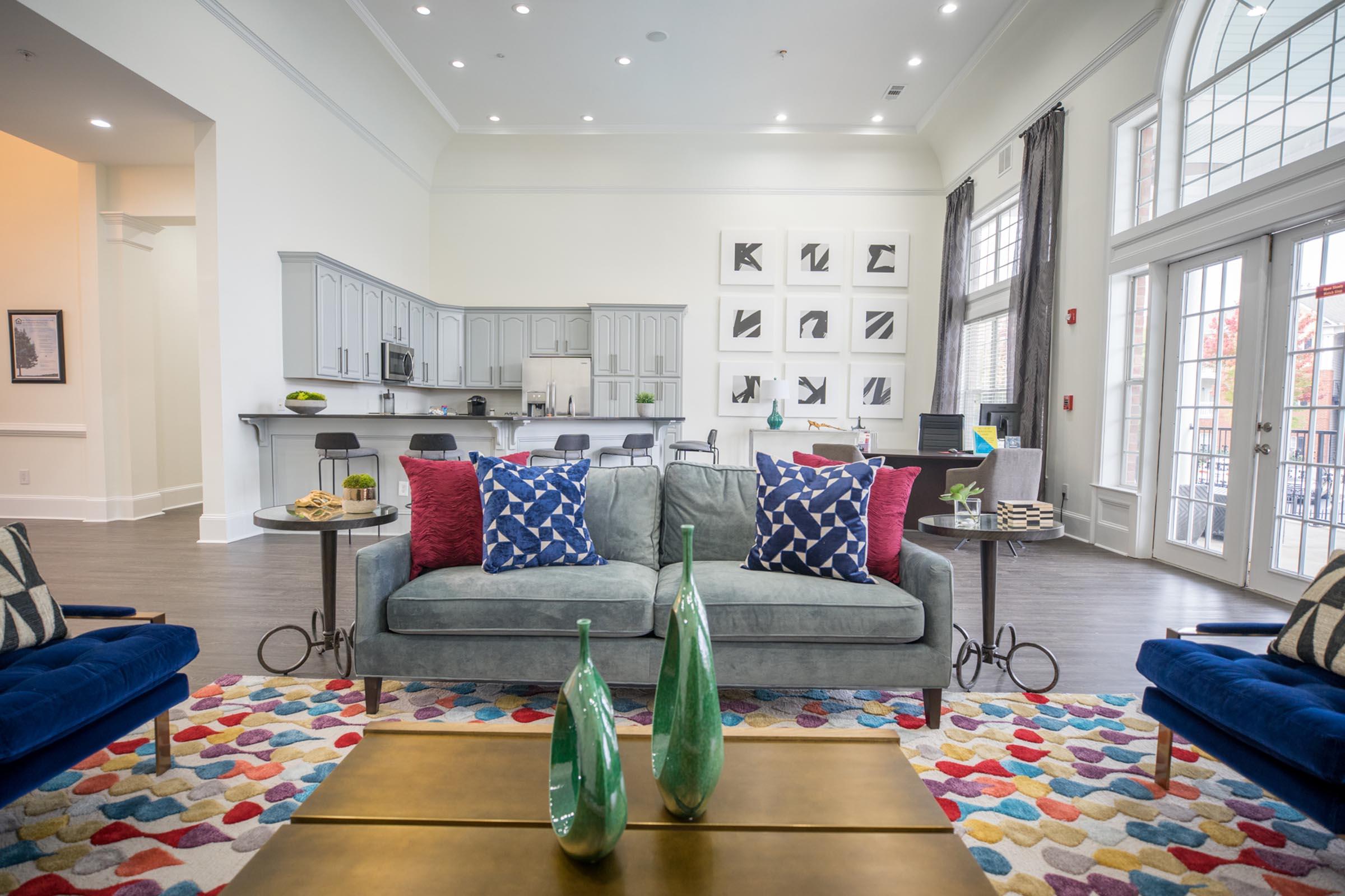 a living room filled with furniture and a large window