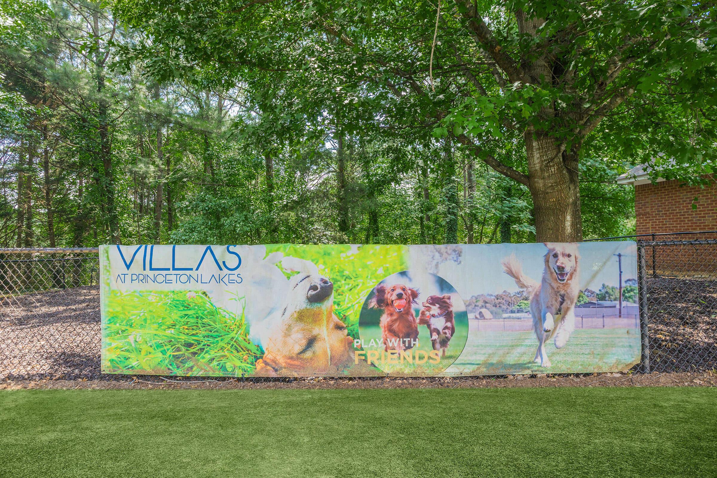 Banner promoting Villas at Princeton Lakes, featuring playful dogs in a green outdoor setting. The text encourages interaction with the phrase "Play with friends," emphasizing a pet-friendly atmosphere. The background includes trees and a grassy area.