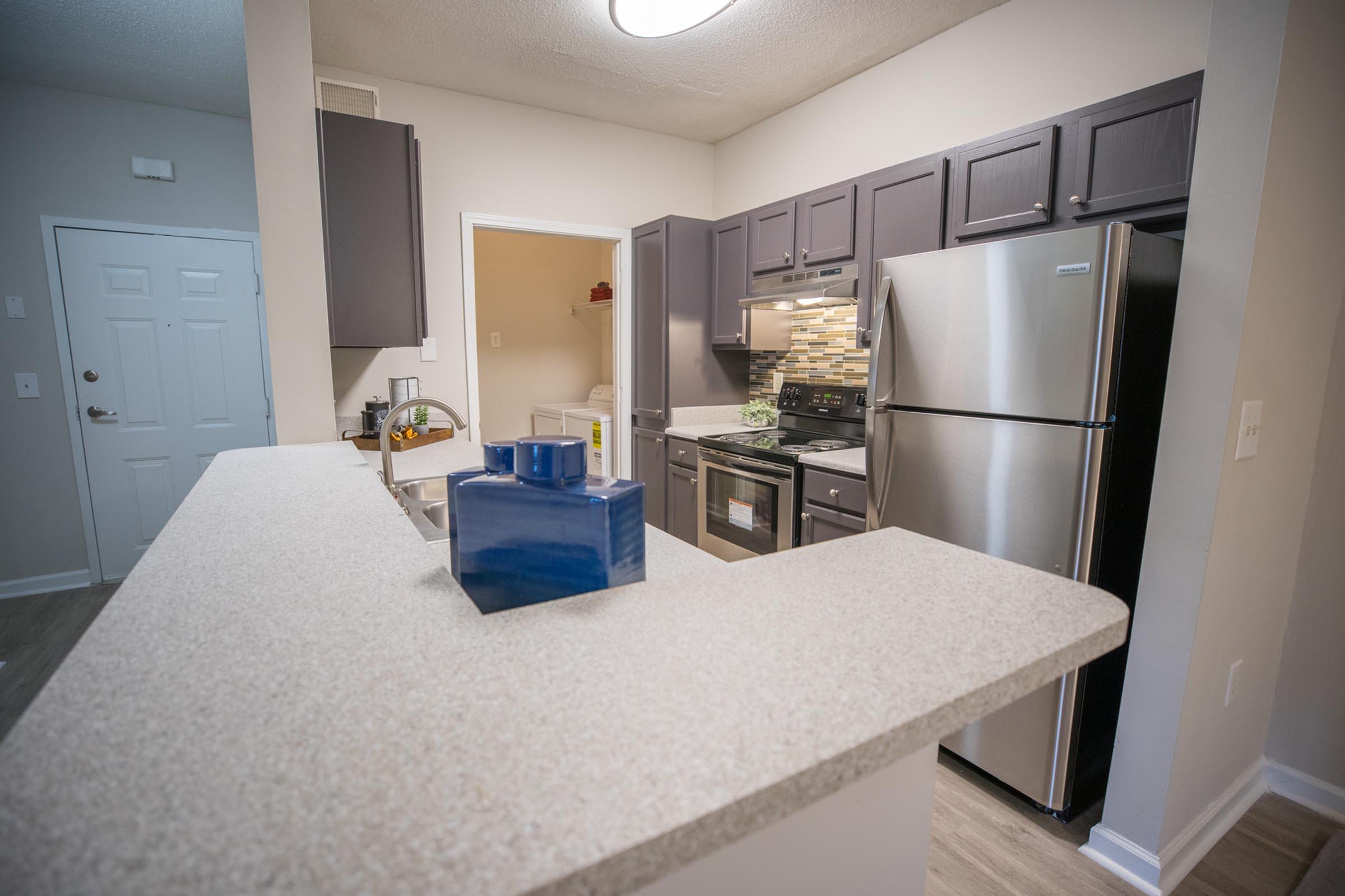 a kitchen with a sink and a refrigerator