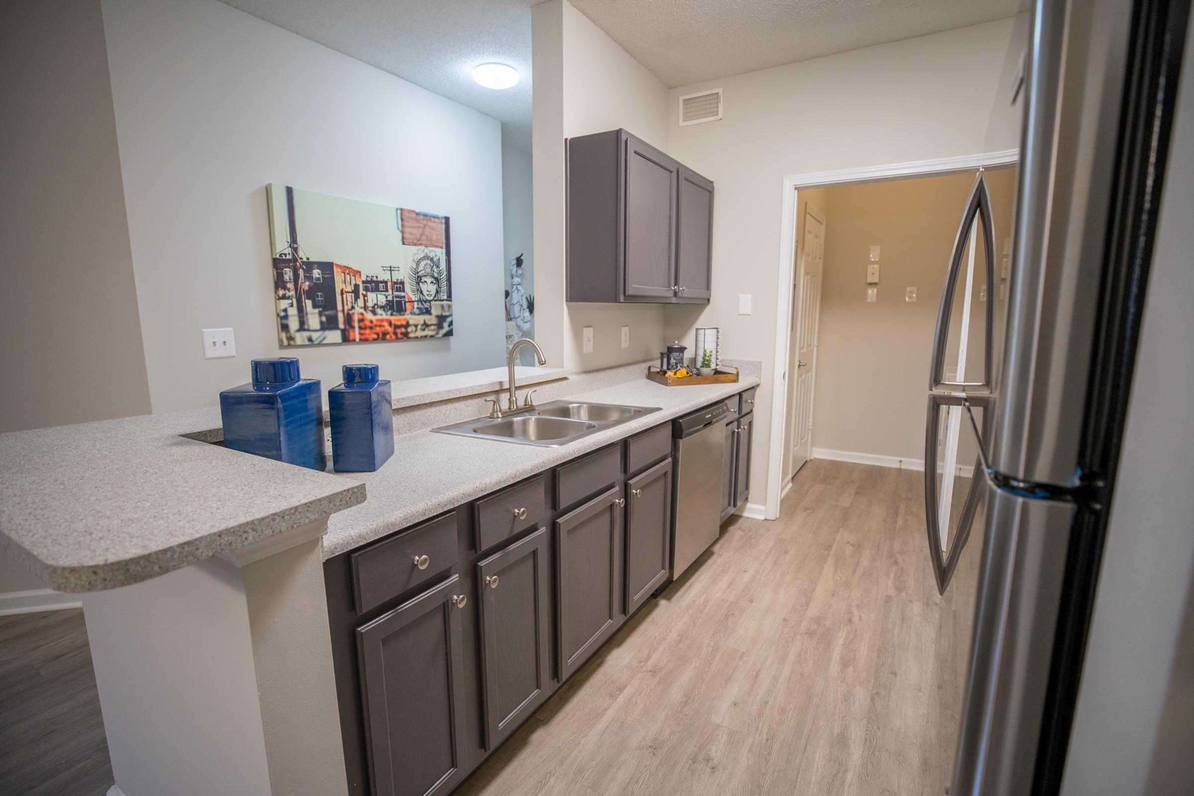 a kitchen with a sink and a mirror