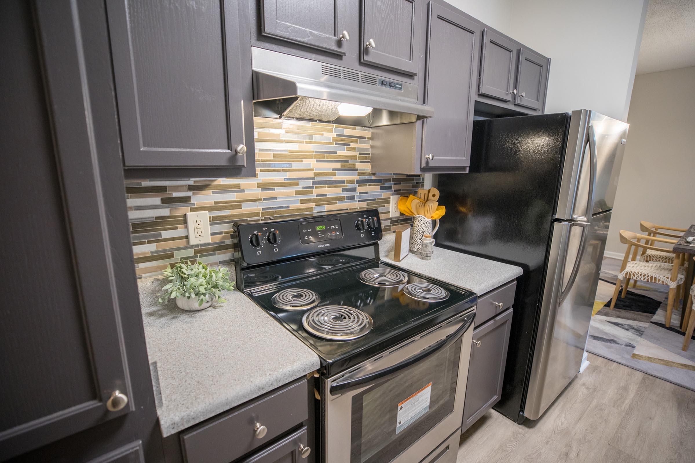 a stove top oven sitting inside of a kitchen