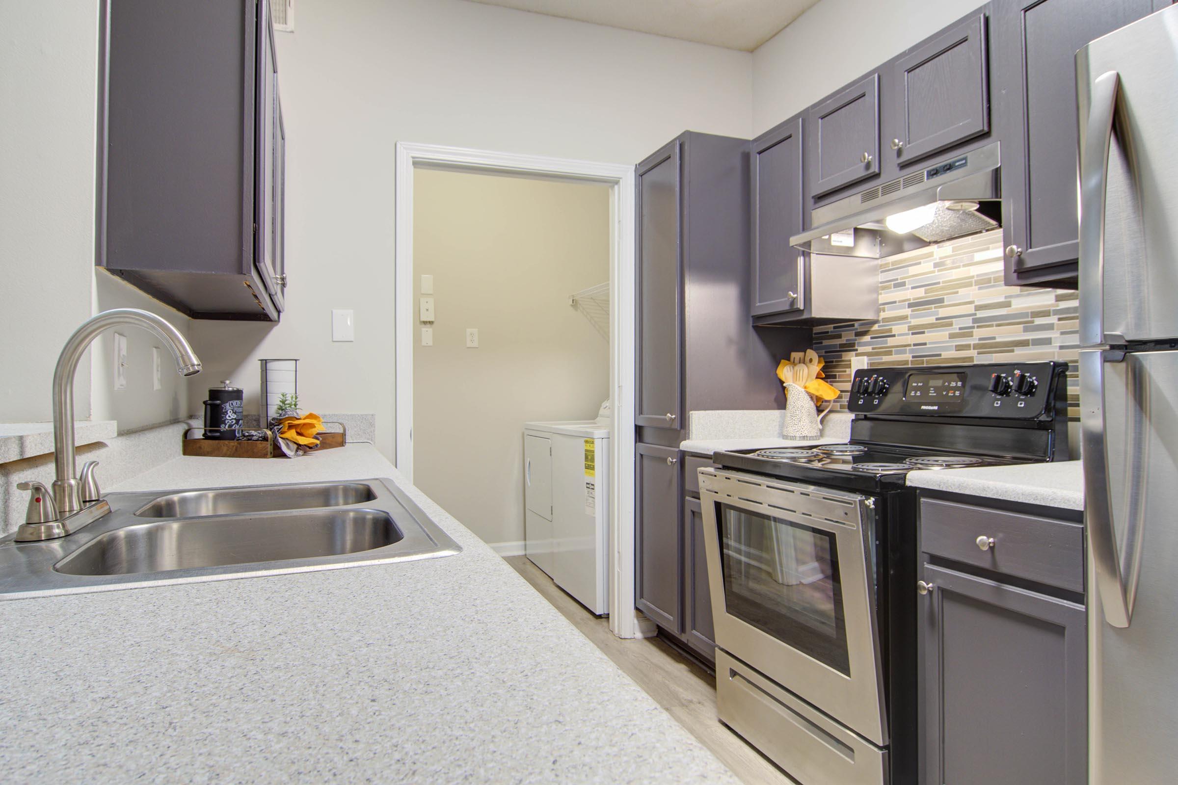 a large kitchen with stainless steel appliances