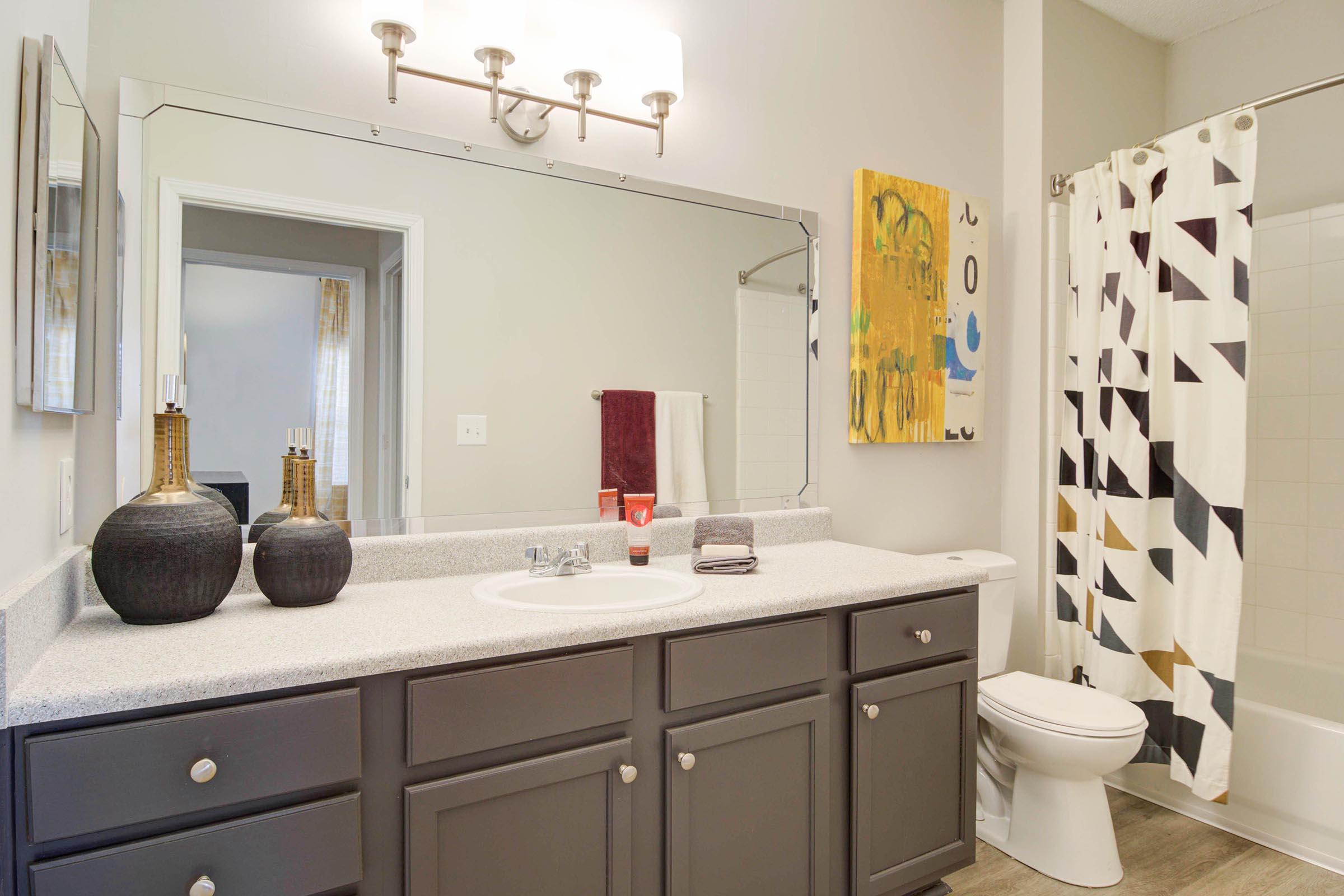 a kitchen with a sink and a mirror