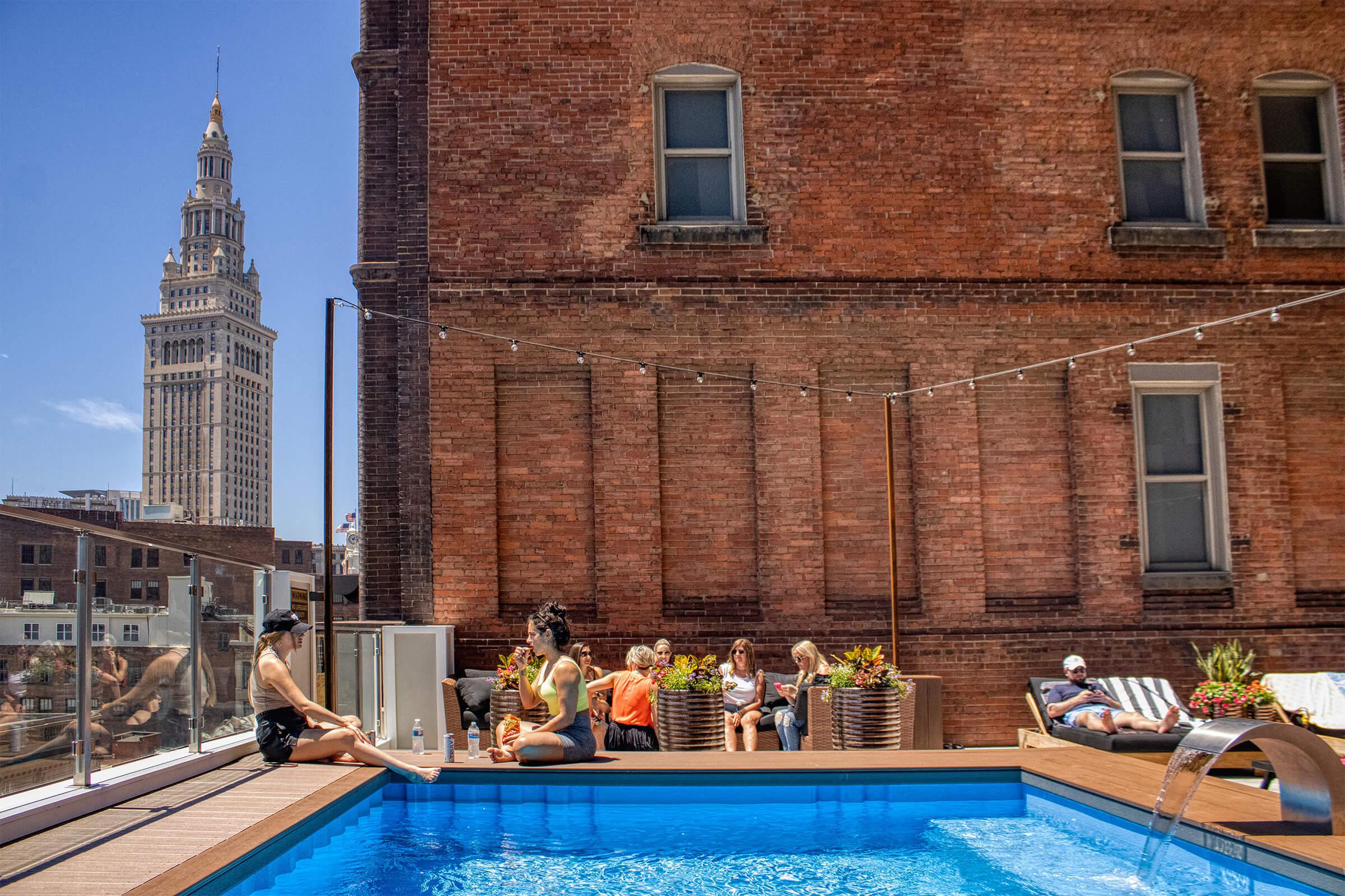 a group of people in a pool of water in front of a building