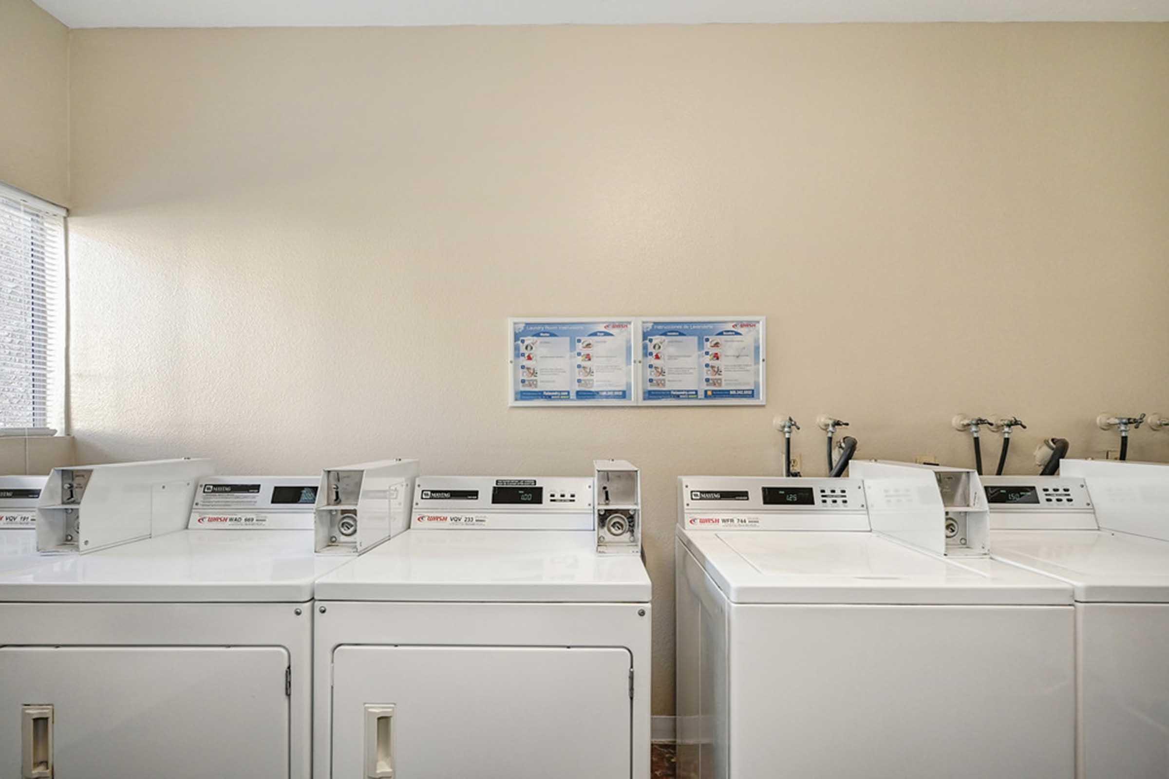 a close up of washers and dryers