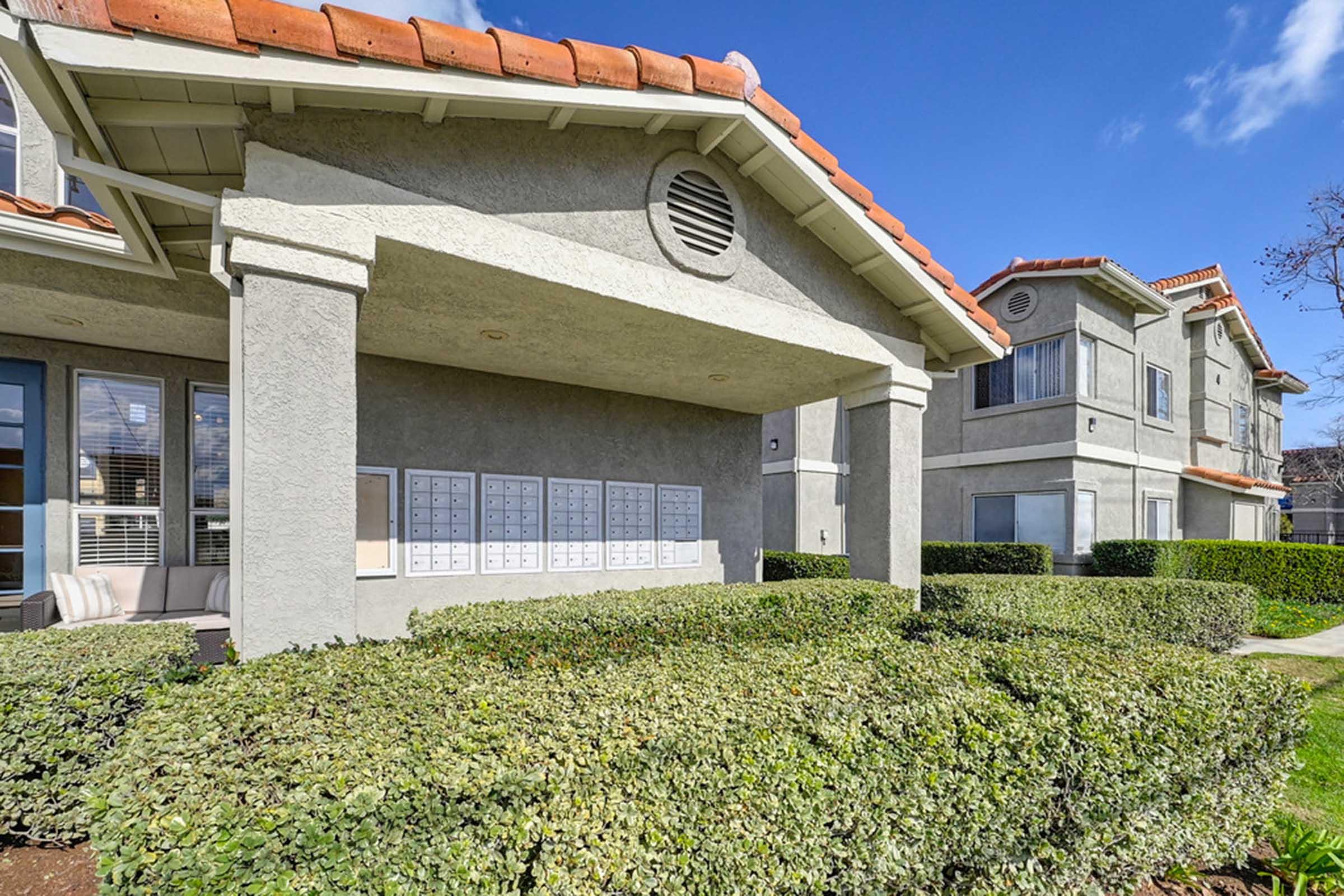 a large building with grass and bushes