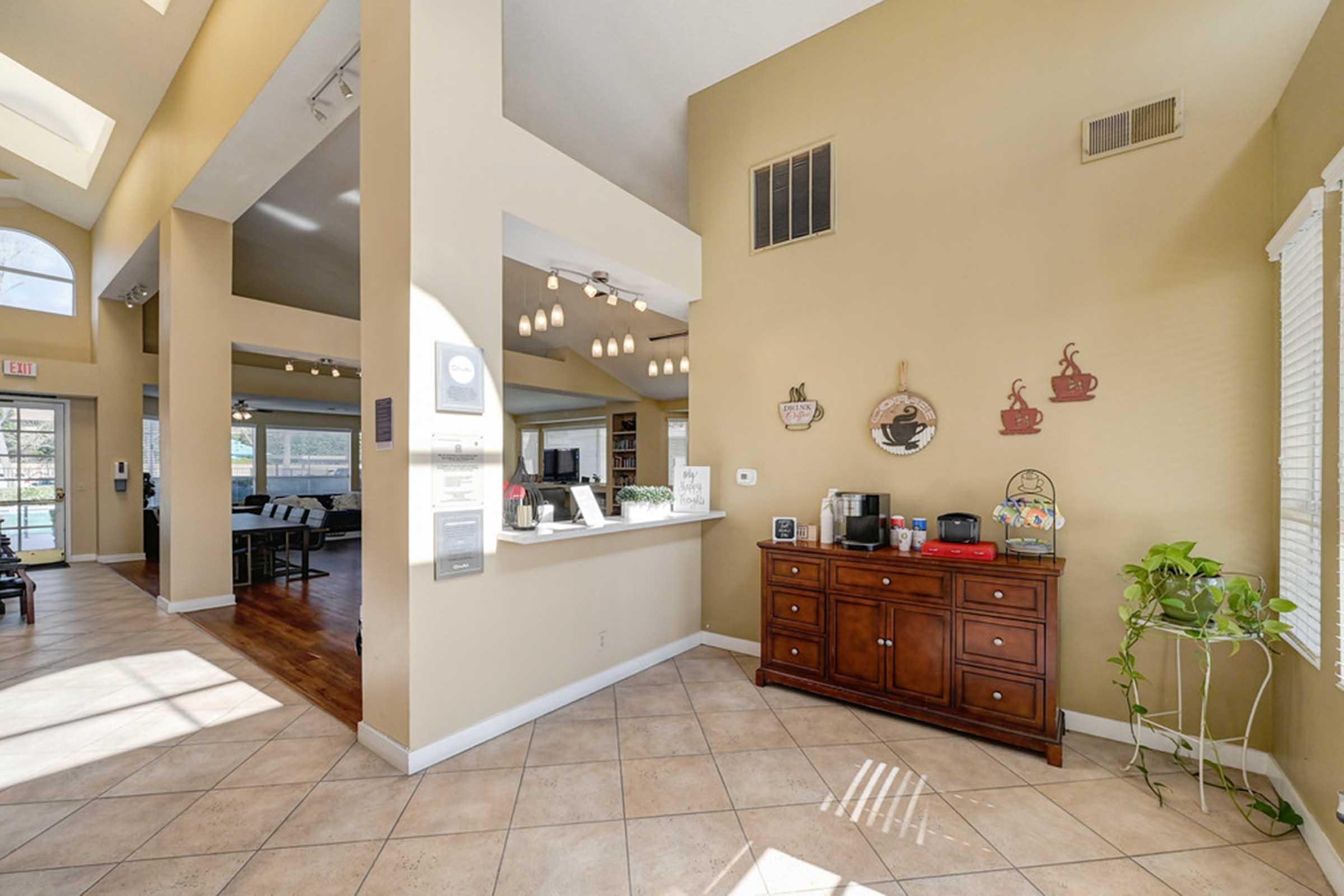 a room filled with furniture and a coffee bar