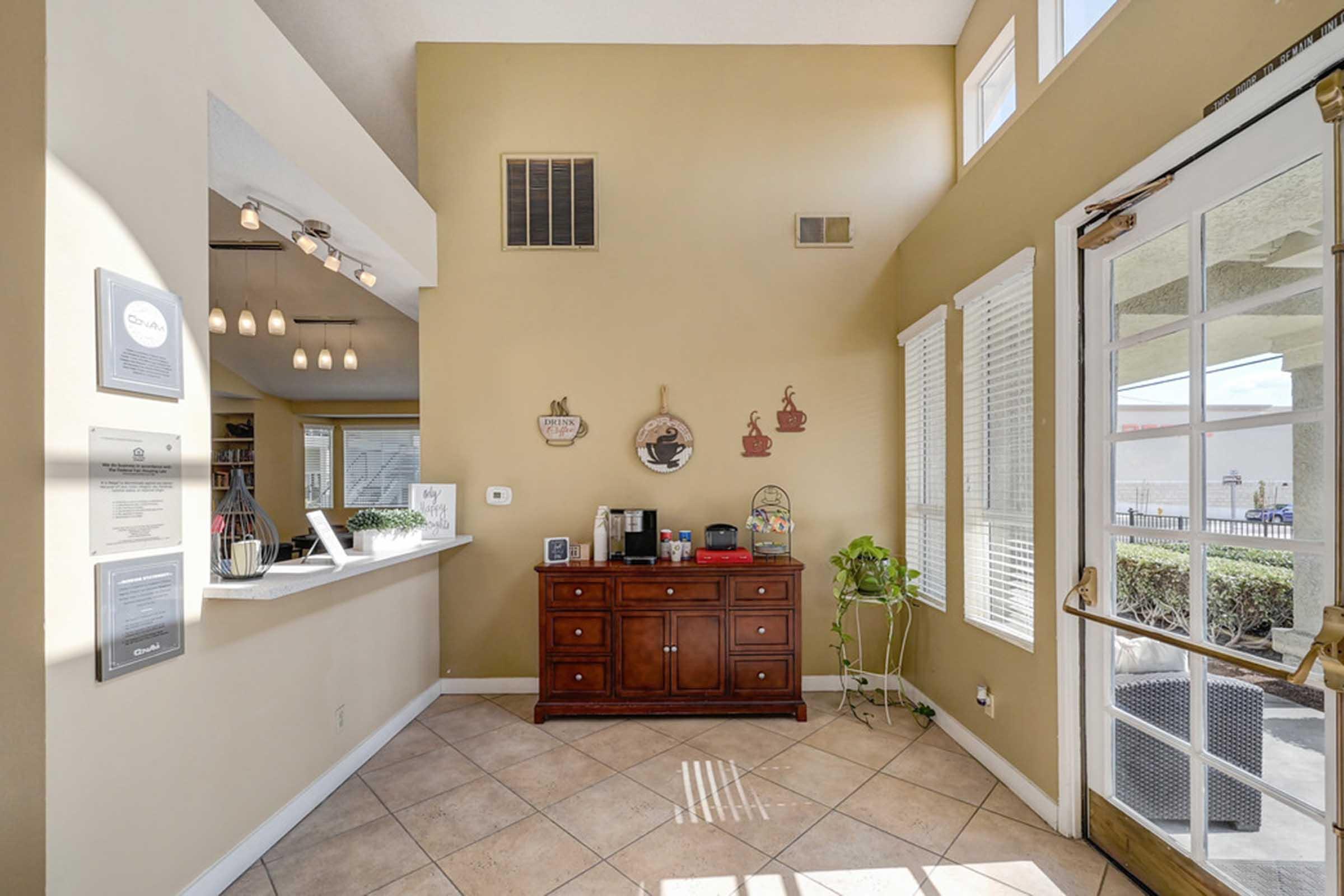 a room with a coffee bar and a window