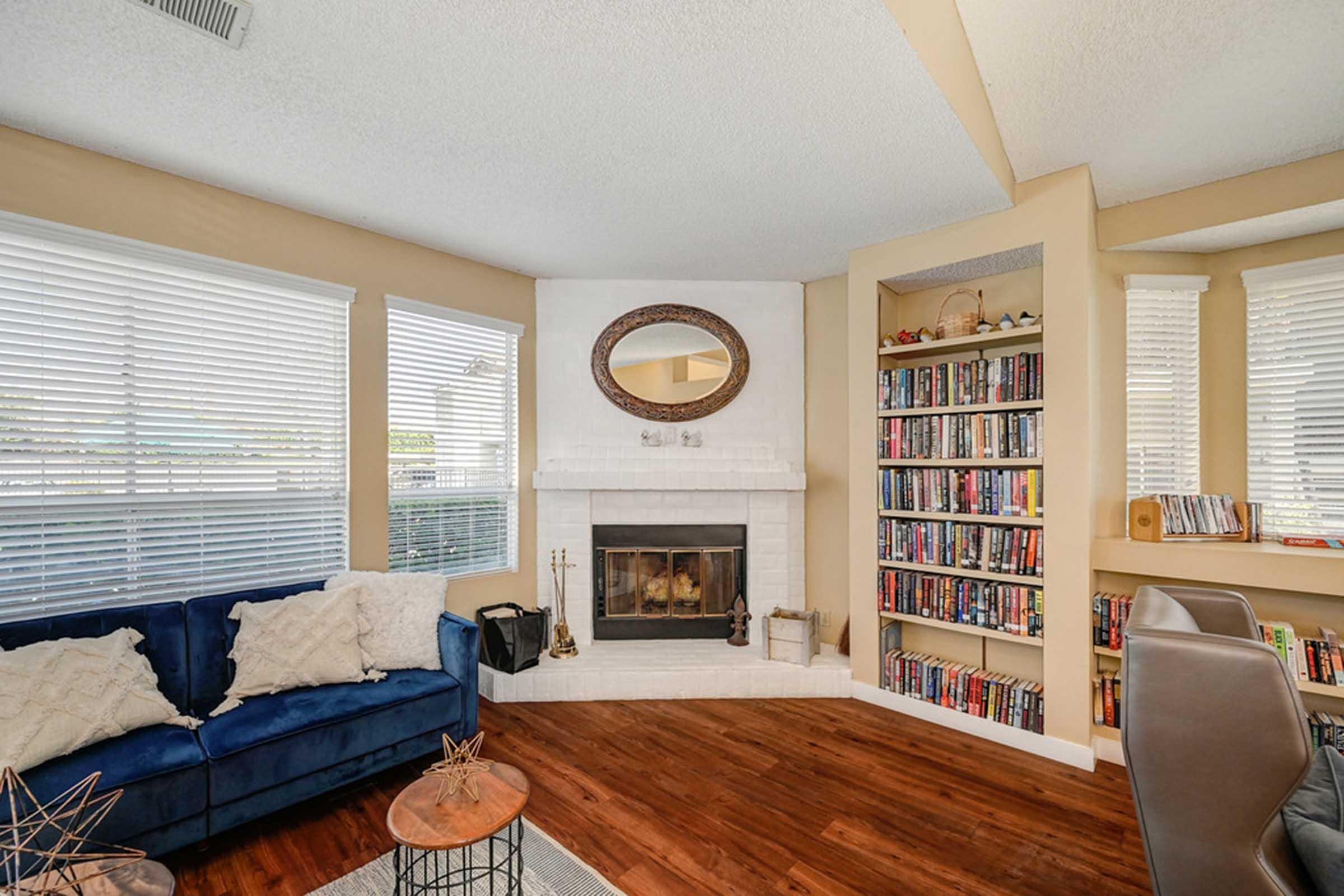 a close up of a fireplace and bookshelf