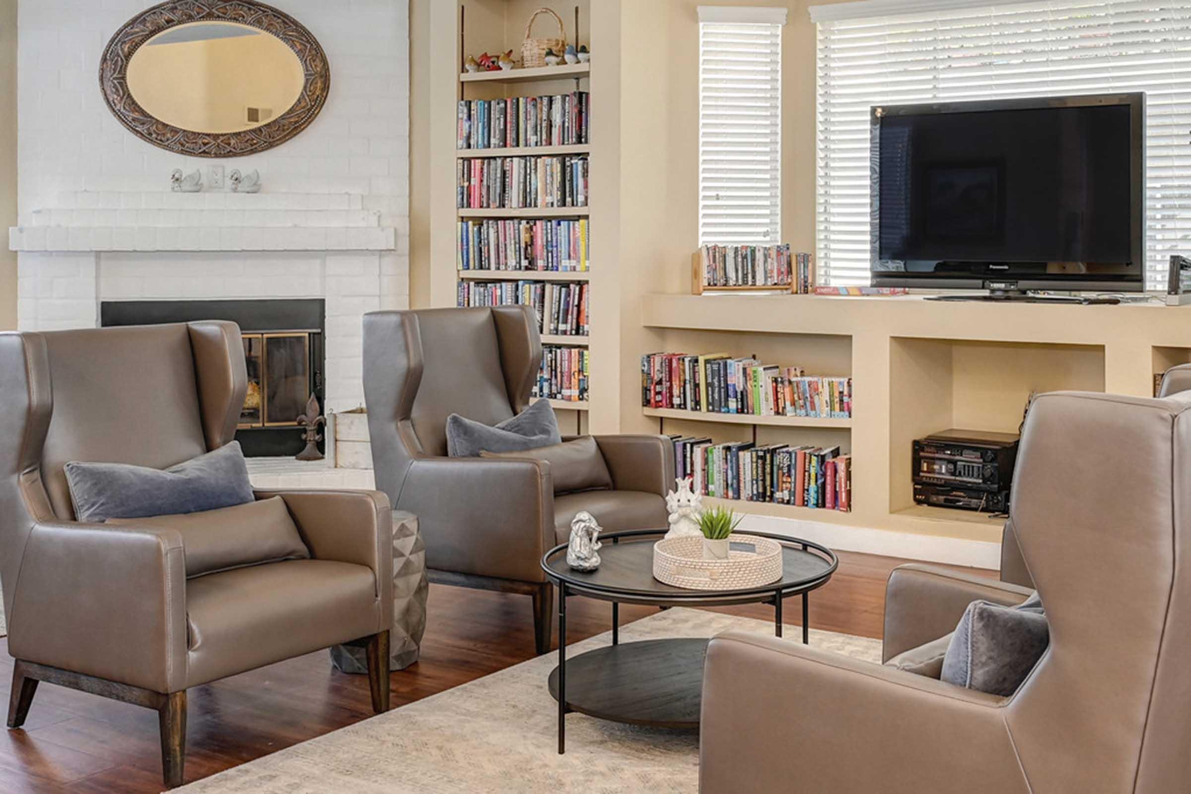 a room with a book shelf and tv