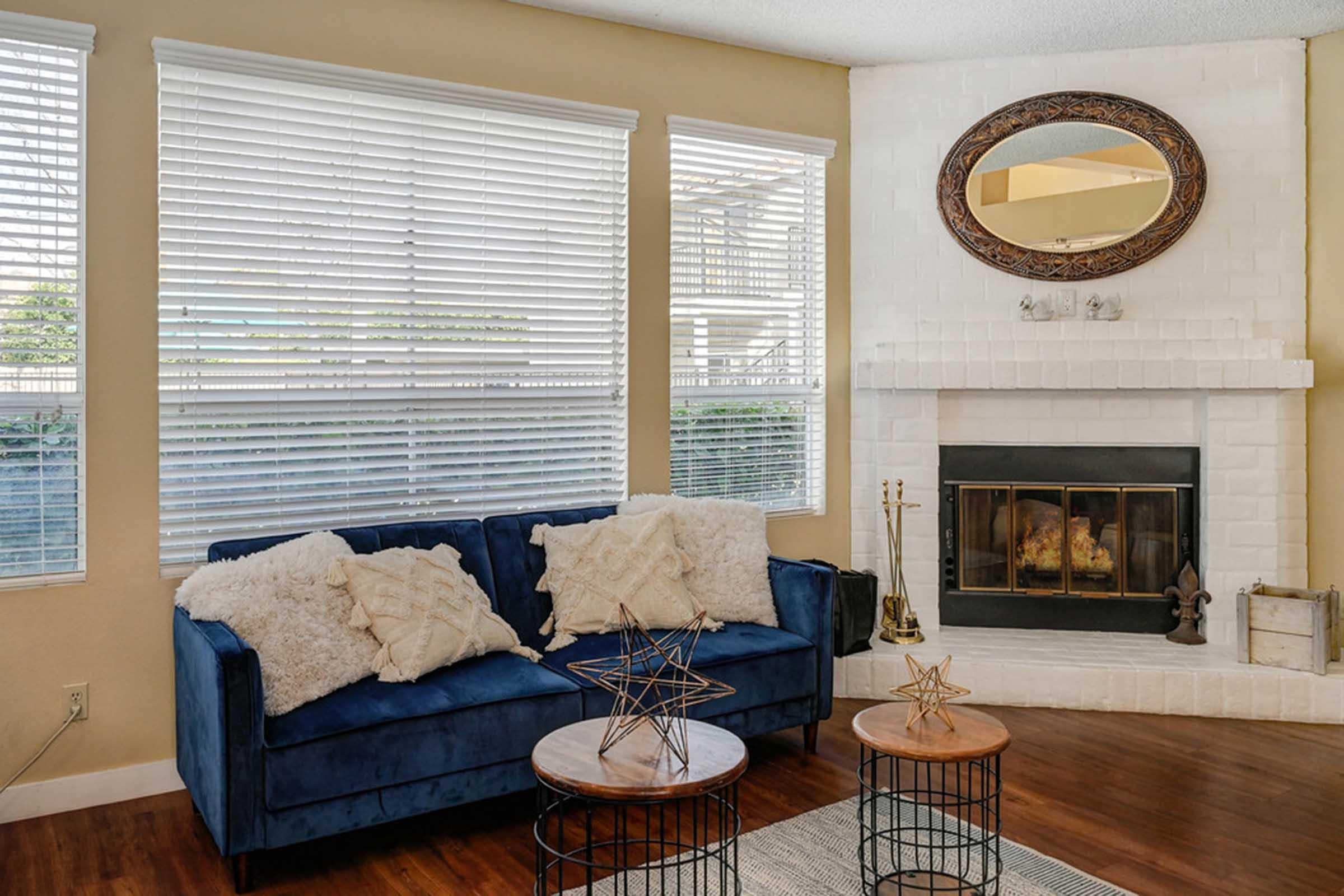 a close up of a couch next to a fireplace