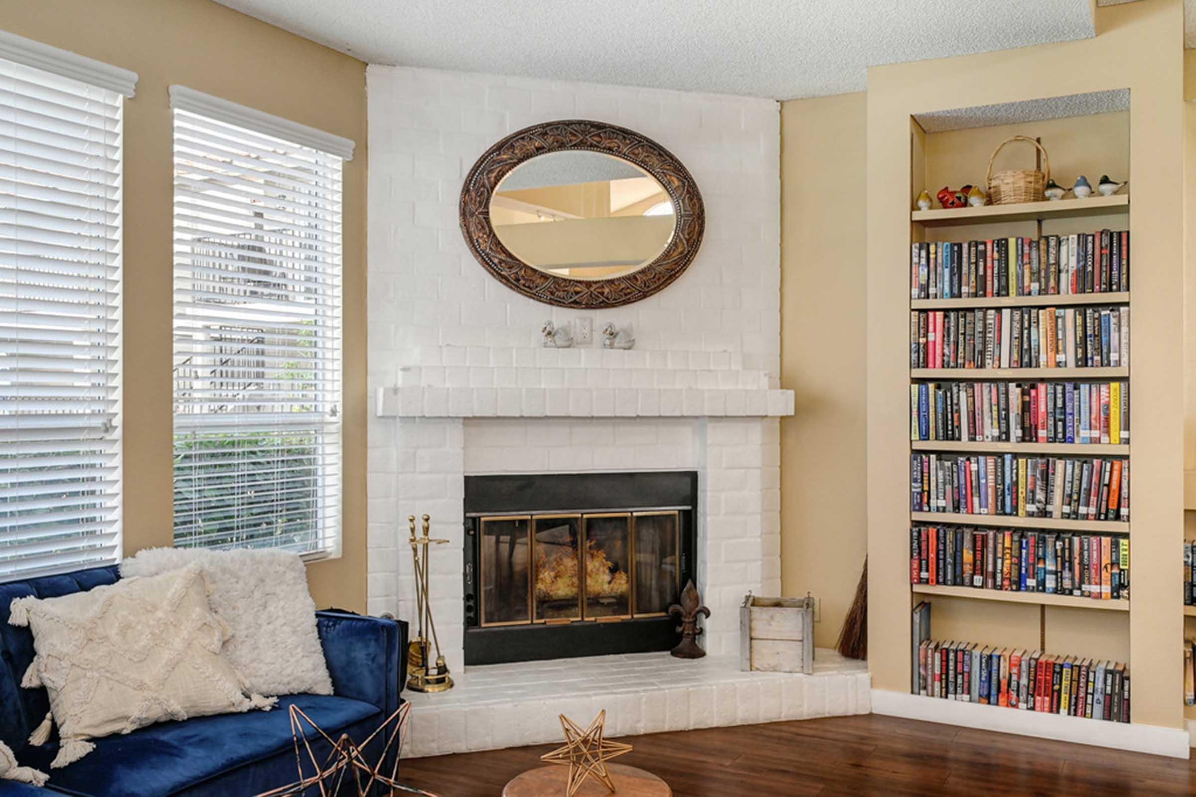 a fireplace and bookshelf